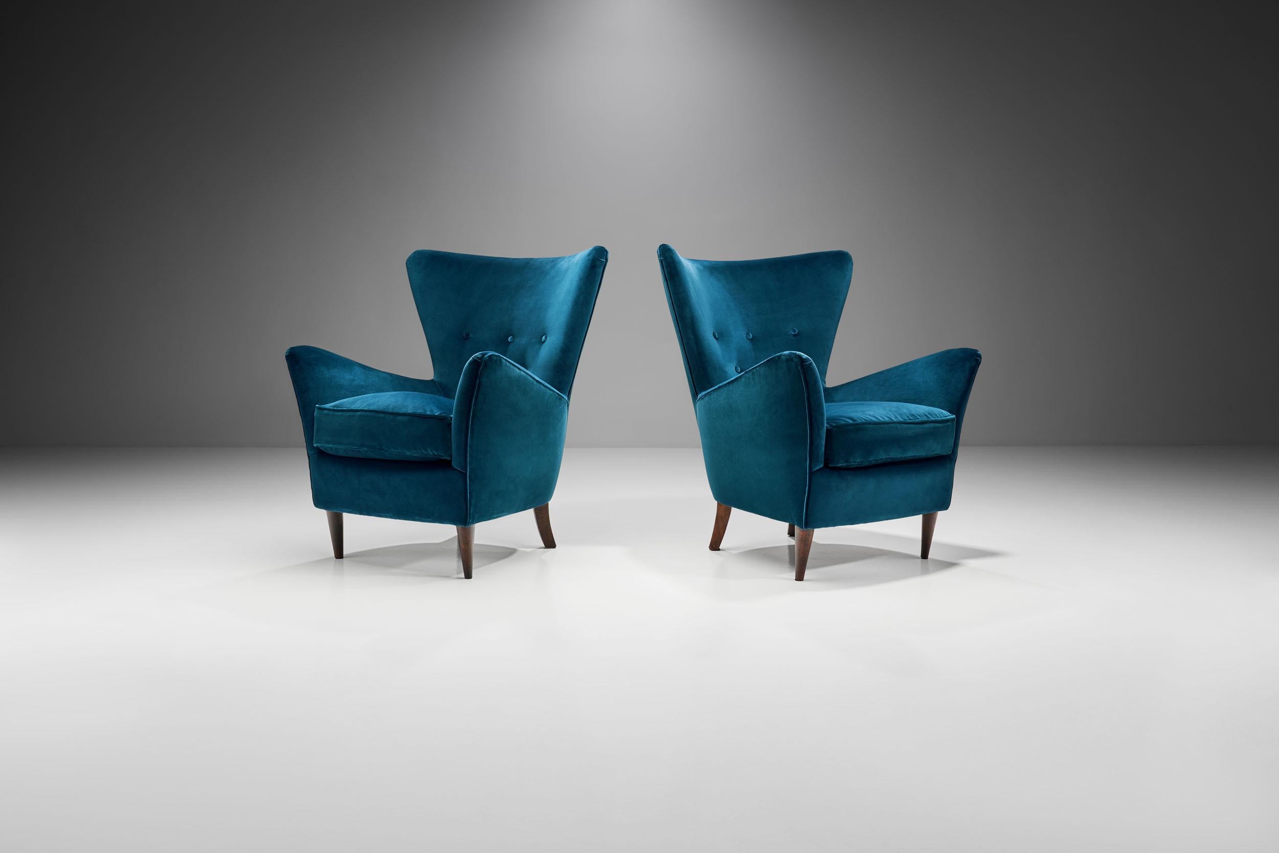 This pair of striking armchairs showcases how and why Italy also excelled in the coveted mid-century modern style. In these armchairs style meets functionality and quality.

Like many of the Italian armchairs of the 1950s, this pair radiates