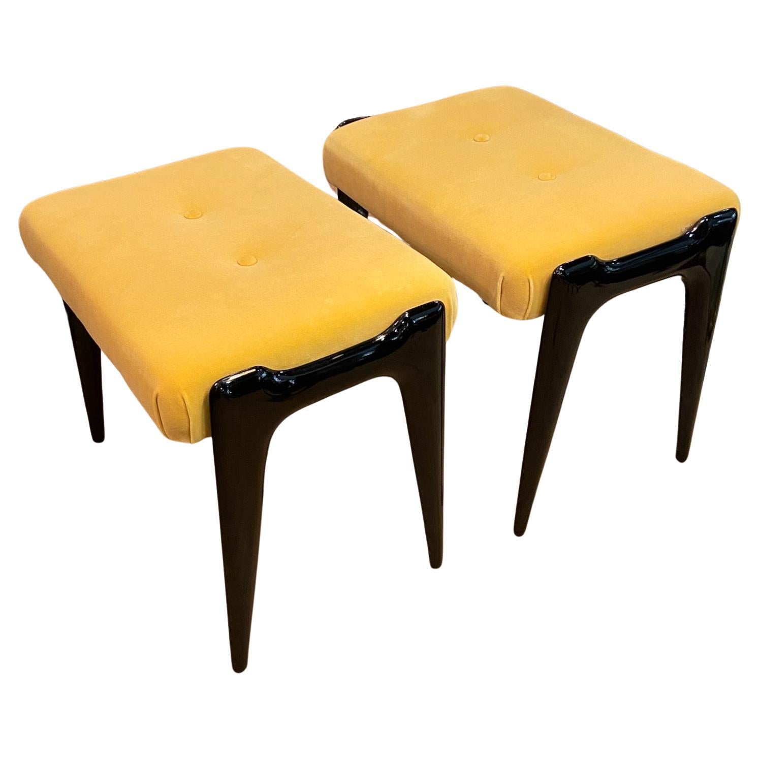 A pair of mid-century Italian stools, yellow velour and ebonized wooden legs
