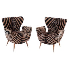 A Pair of Mid Century Italian wing back chairs by Paolo Buffa. Circa 1950.