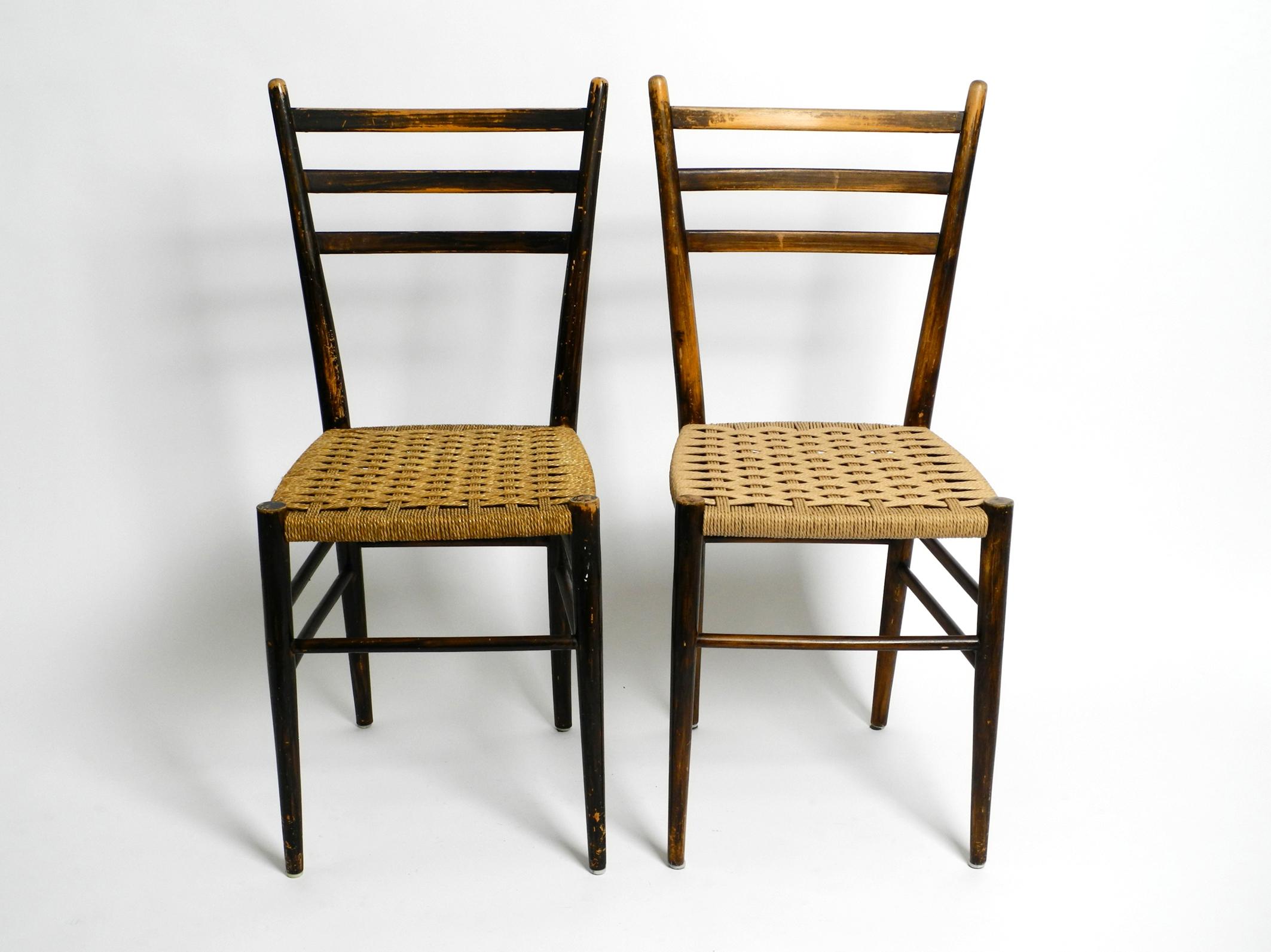 A pair of beautiful mid-century wooden dining chairs with woven cord seats.
Great minimalist design with a dreamlike patina. Made in Italy.
Very well preserved with no damage to the wooden frame and weave.
The braided cord on one chair has been