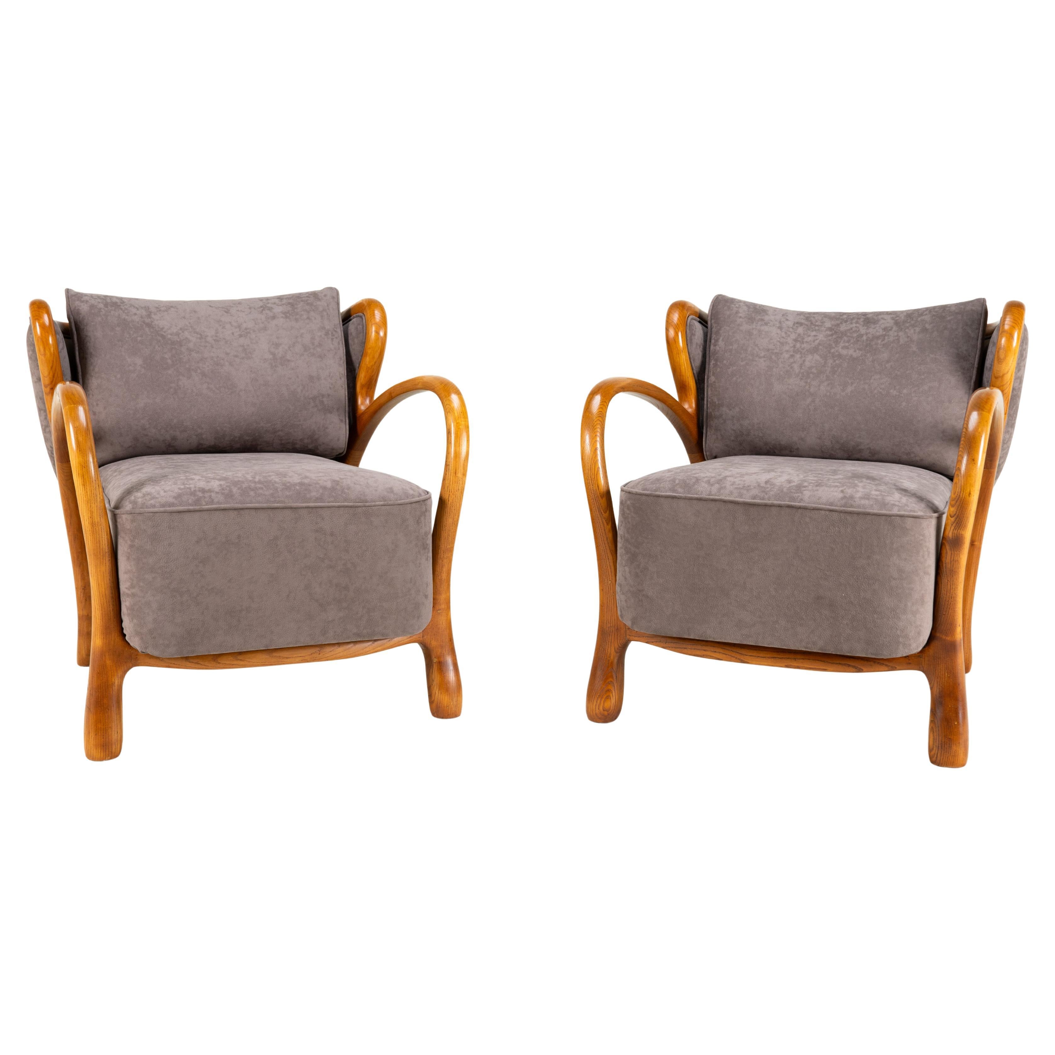 A Pair of Mid-Century Lounge Chairs with Solid Wood Arms