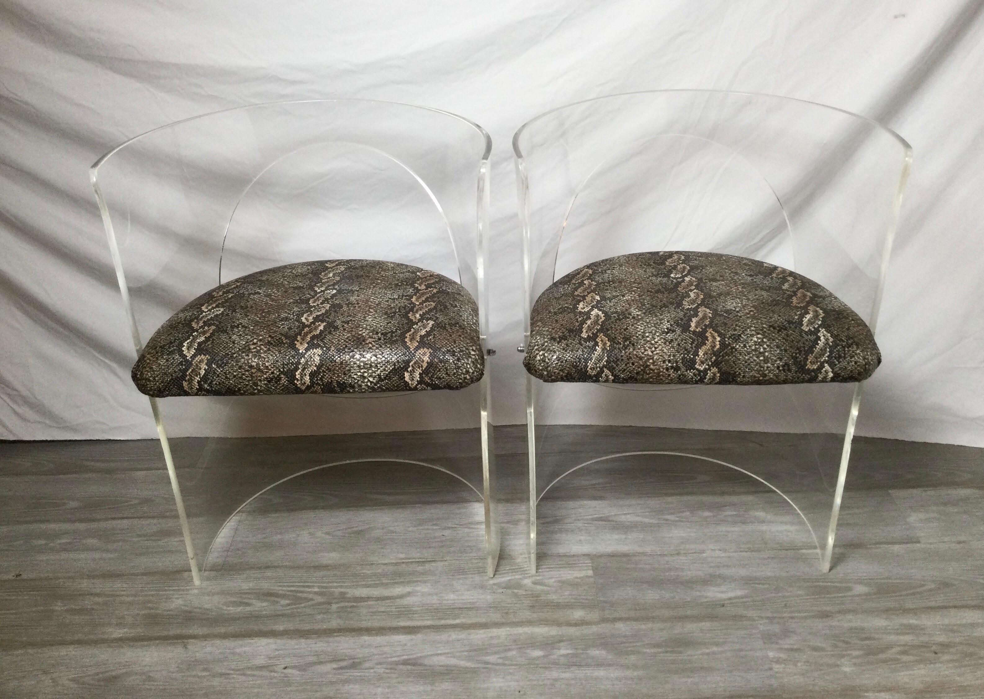 A pair of Lucite tub chairs with faux vinyl snake shin seats. Designed by Charles Hollis Jones, the rounded backs with upholstered seats with a python pattern vinyl, 1960s.