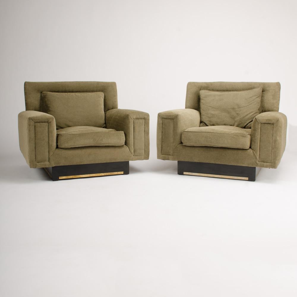 An imposing pair of large Mid-Century Modern club armchairs, circa 1960, professionally reupholstered with new fabric.