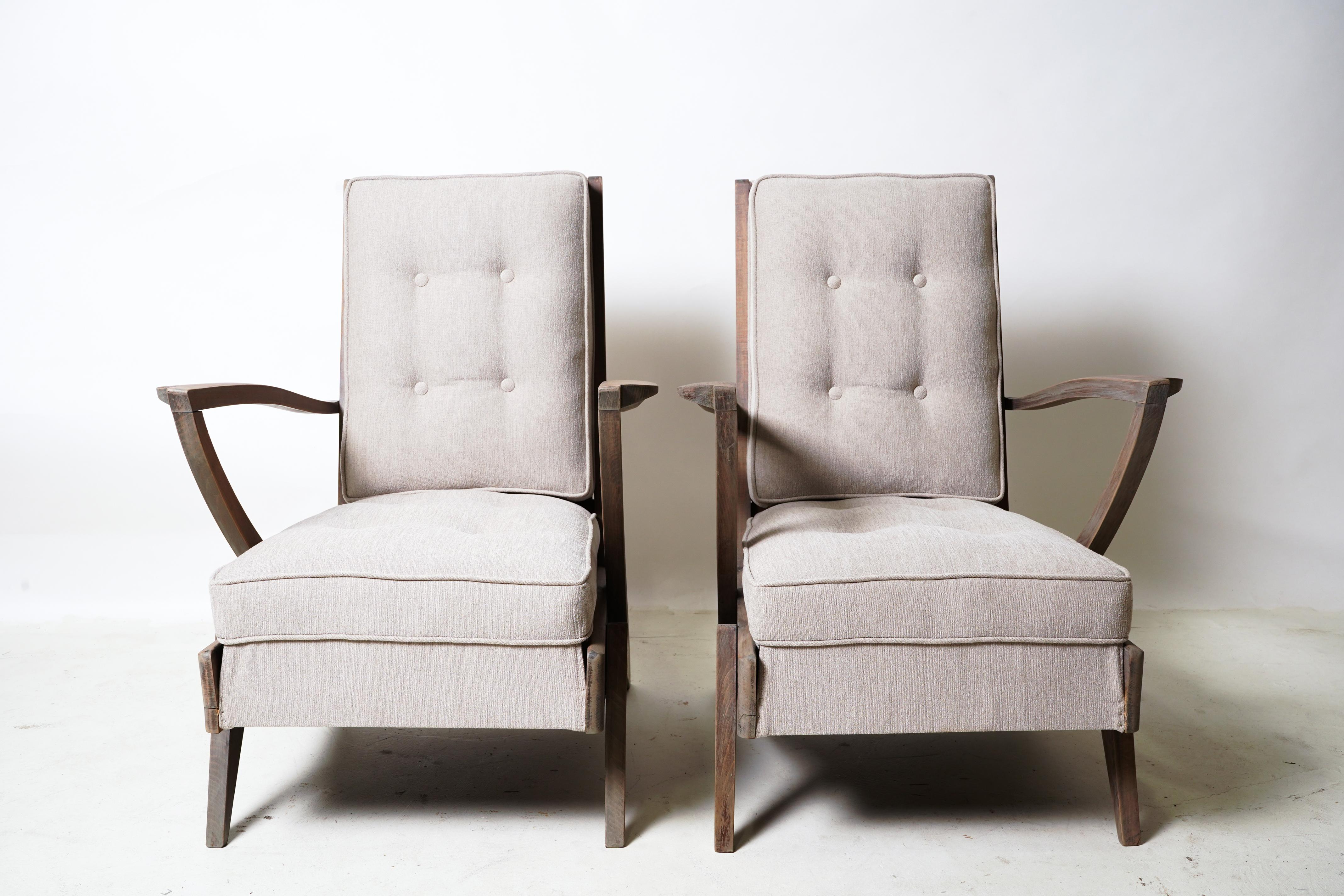 These unique lounge chairs feature solid Beech Wood arms and legs that have an unusually angular design. The chairs are modest in scale and easy to blend into a variety of interior design schemes. The original varnish (much of it worn) was removed
