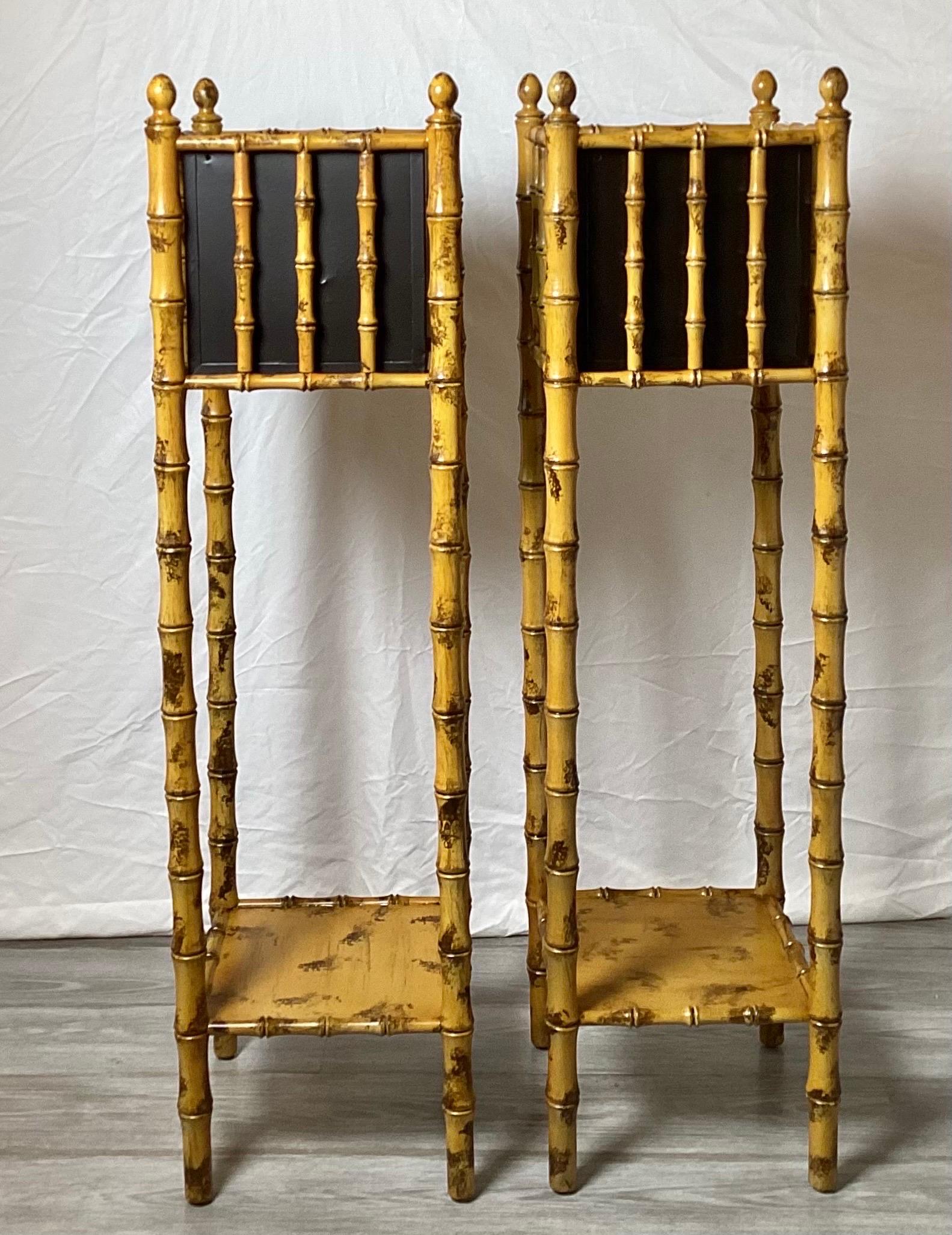 A pair of faux hand painted bamboo motif tall platers with black tin liners. The hardwood turned wood frames faux hand painted in bamboo style with original black tin liners, 4405 inches tall, 1960's.