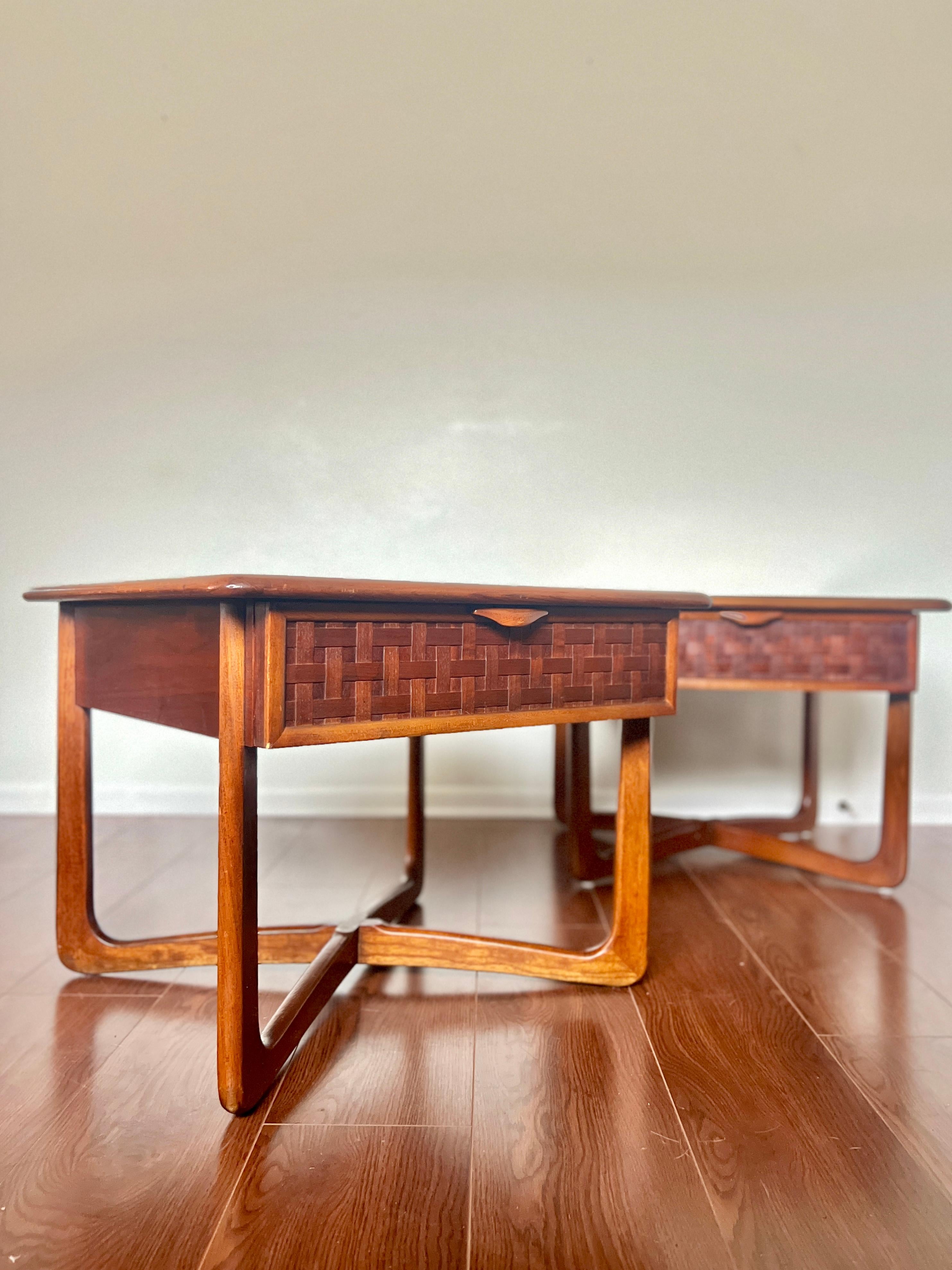 A pair of Mid-Century Modern lane perception side tables with a cross cross base. Quality American construction paired with fine design. Top surface is walnut wood with contrasting oak trim tracing the perimeter. Elegant woven wood facade and solid