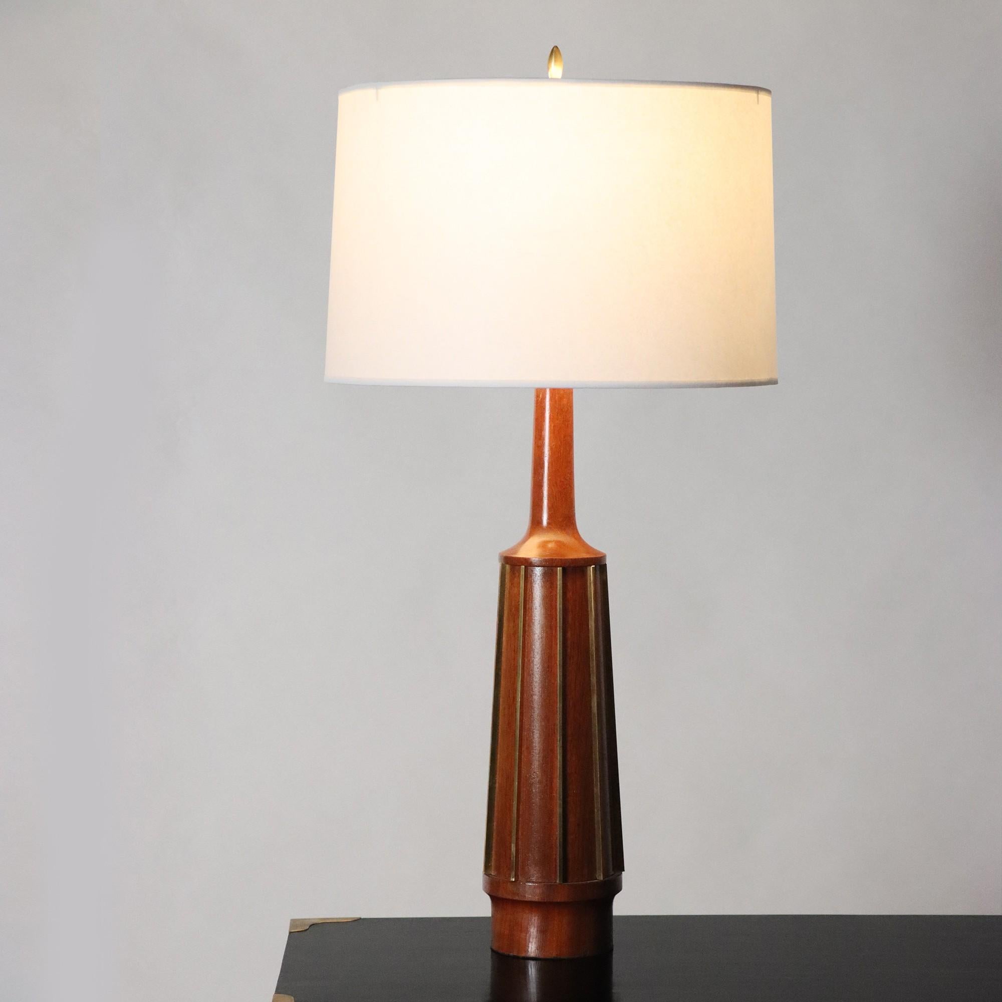 An elegant pair of Mid Century Modern table lamps by G. Thurston, circa 1950. Teak Wood and Brass details. Circa 1950.