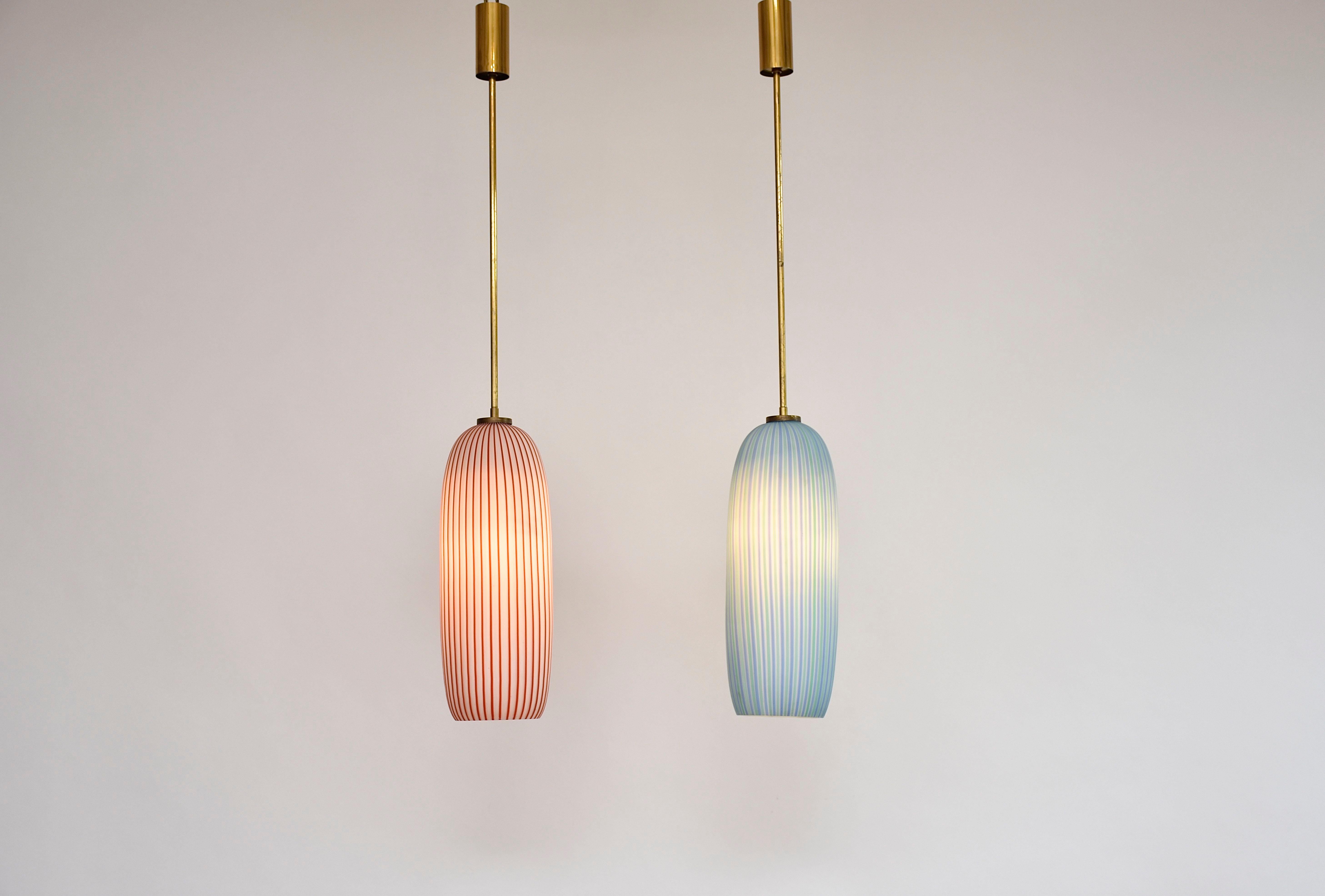 A beautiful pair of 2 mid-century lamps in two cheerful colors.
Hand blown cylindrical Murano pendants with striped pattern. 
Beautiful quality!
Brass frame and ceiling cover.
