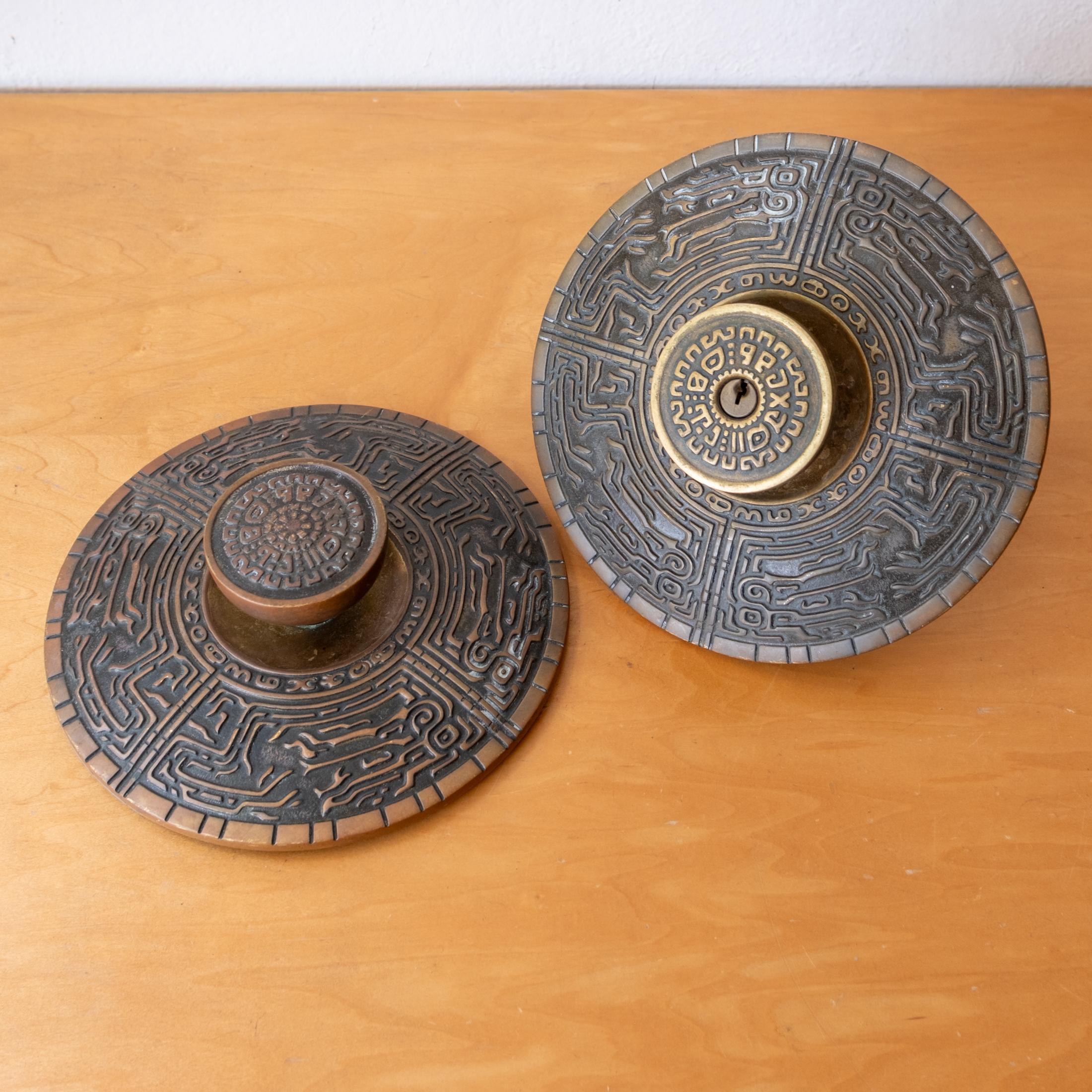 A pair of Mid-Century Oversized Schlage Mayan Motif Door Knobs and Escutcheon Plates. Great for double doors. Can be re-keyed and installed with interior knobs. Nice patina. Super rare to find a pair.   