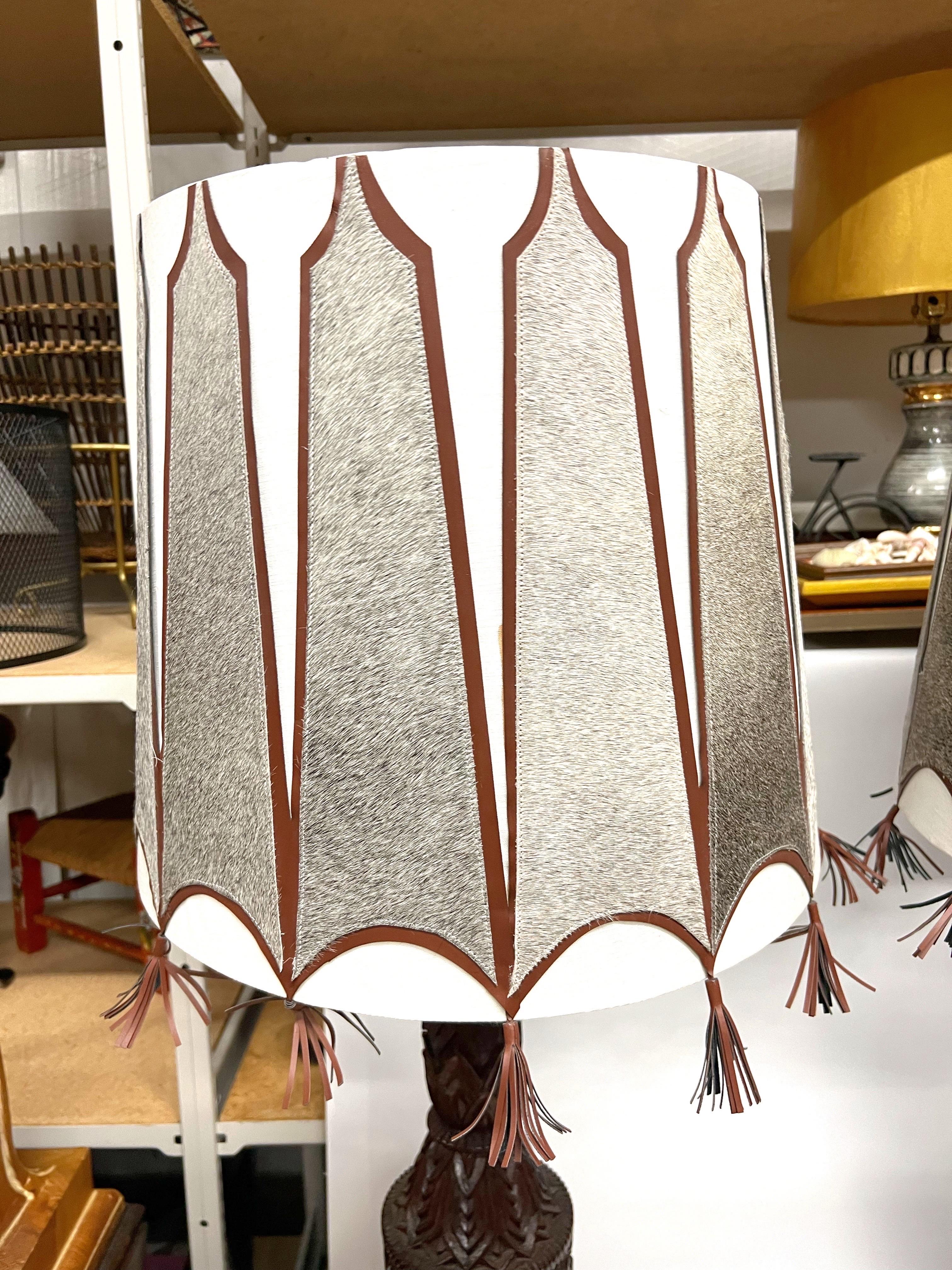 Mid-Century Modern A pair of Mid-Century Tall Carved Wood Relief Lamps With Leather and Fur Shades For Sale