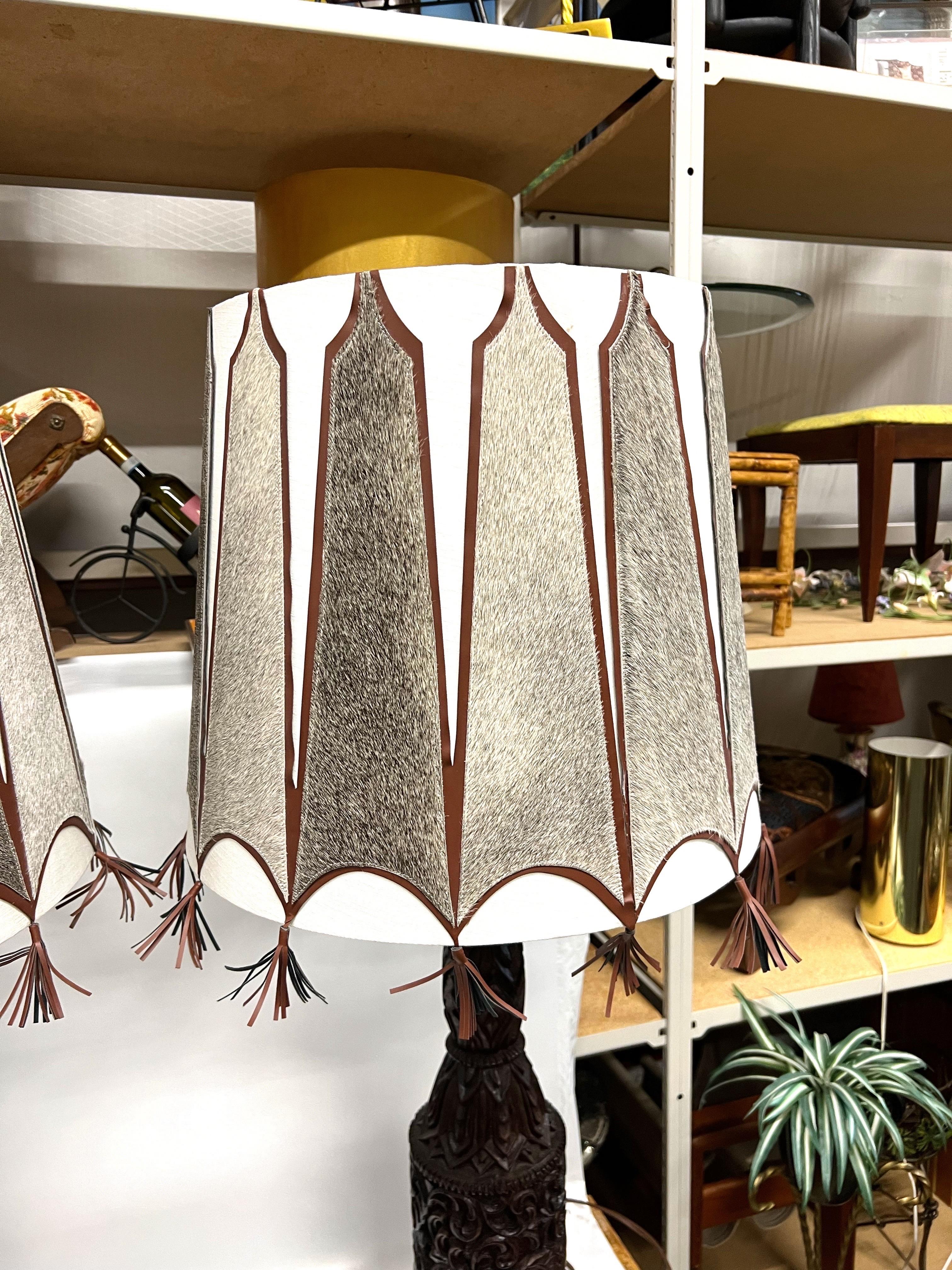 Unknown A pair of Mid-Century Tall Carved Wood Relief Lamps With Leather and Fur Shades For Sale