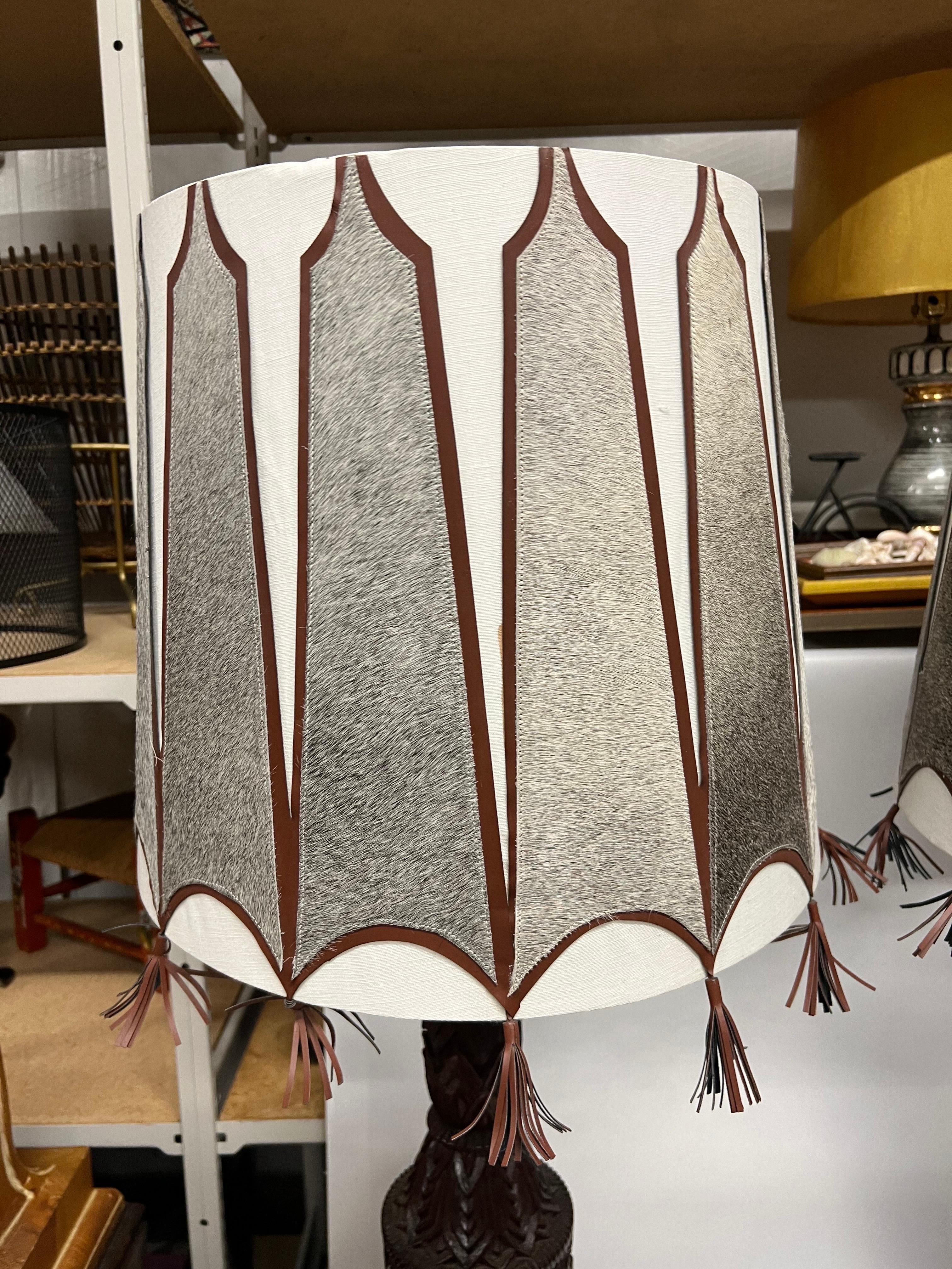 A pair of Mid-Century Tall Carved Wood Relief Lamps With Leather and Fur Shades In Good Condition For Sale In Charleston, SC