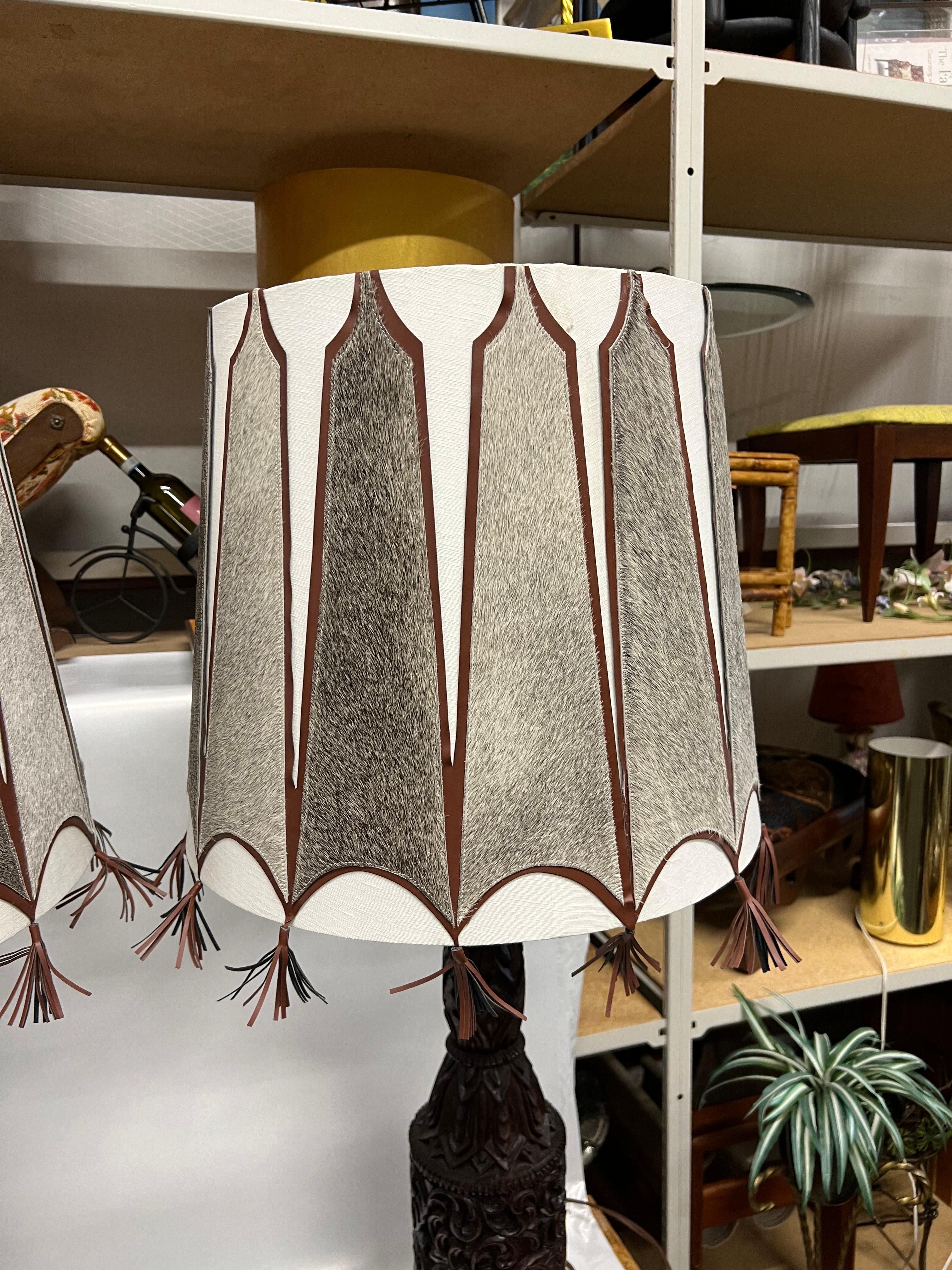 20th Century A pair of Mid-Century Tall Carved Wood Relief Lamps With Leather and Fur Shades For Sale