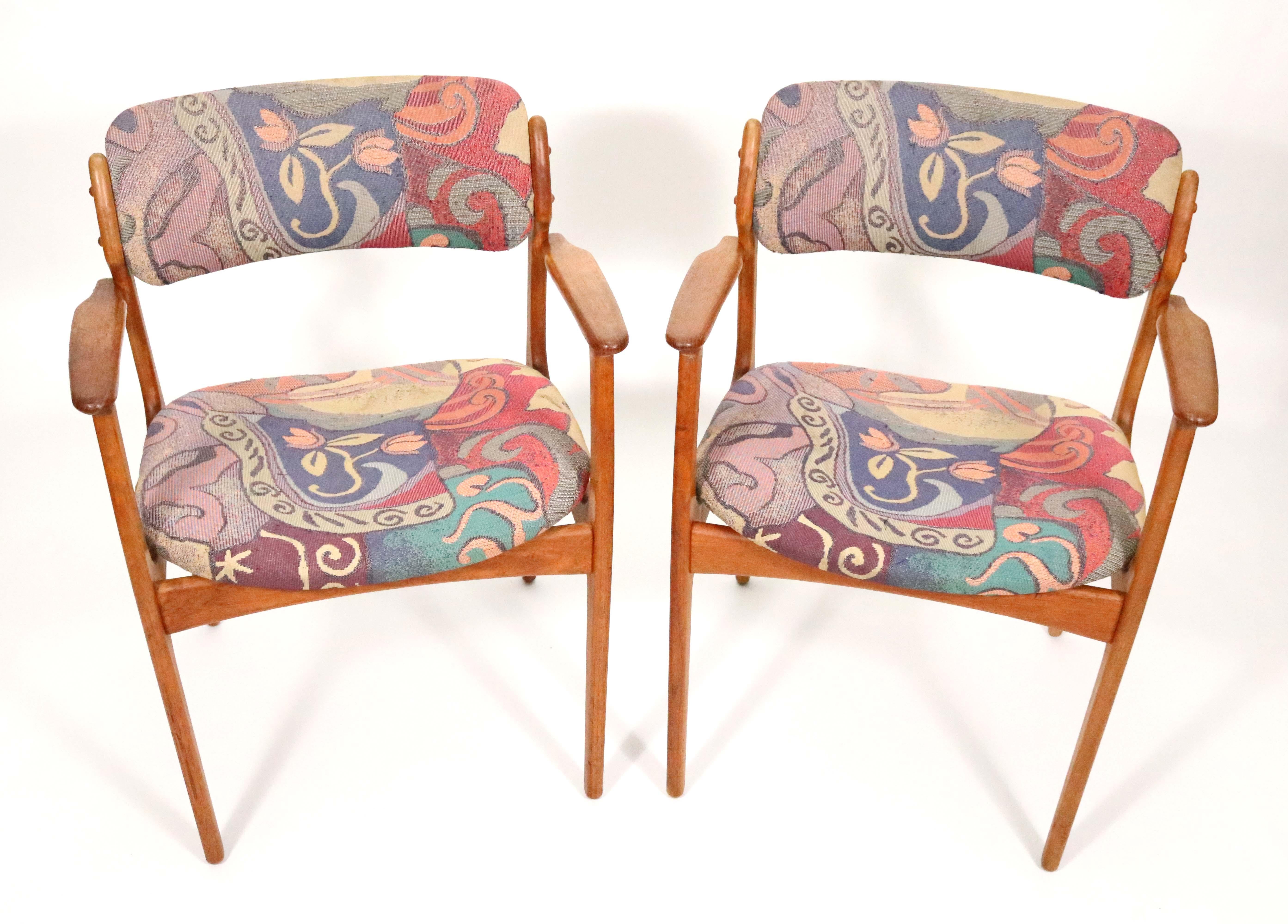 A handsome pair of teak dining armchairs by Erik Buch for Oddense Maskinsnedkeri, Denmark, 1960s.

Simple, solid construction with elegant lines and a comfortable floating seat design. Use them with side chairs for dining, or occasional chairs for