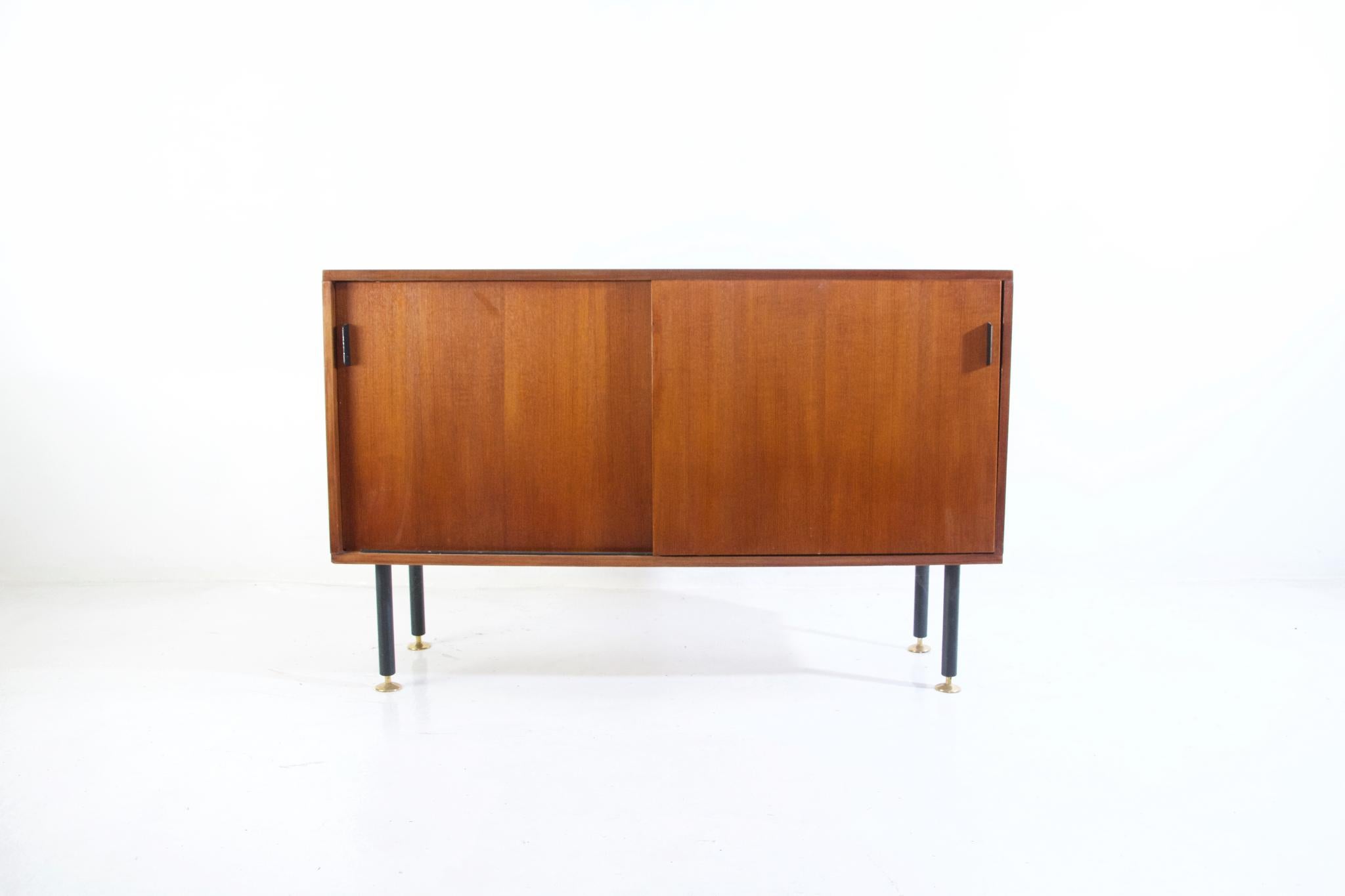 A single credenza in teak with sliding doors by german designer Herbert Hirsche, a Bauhaus Scholar, for producer Christian Holzäpfel. In very good condion with nice patina. 