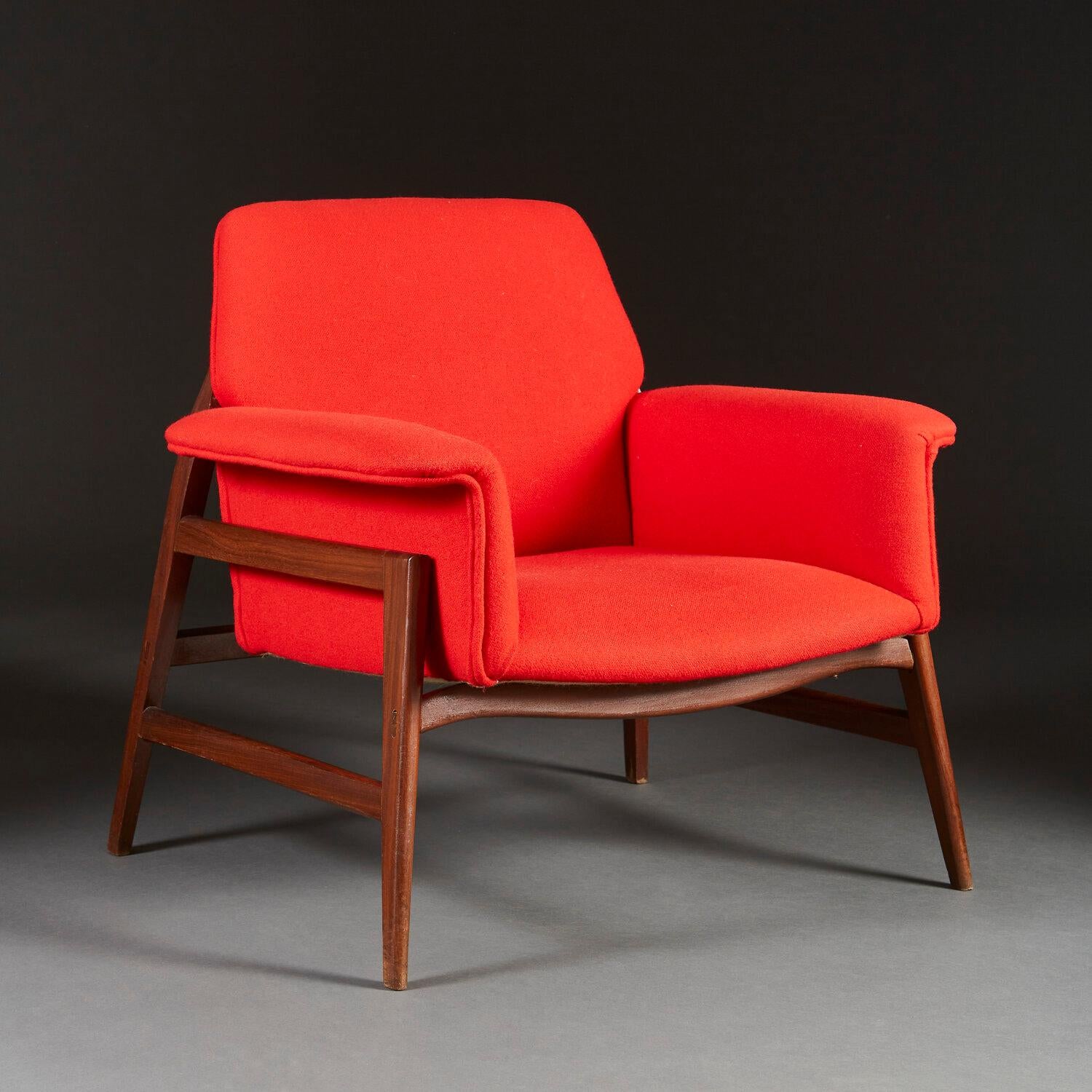 A pair of mid twentieth century Italian armchairs with outswept arms, the seat and back upholstered in a crimson red Danish wool, and supported on a teak wood base with tapering legs.