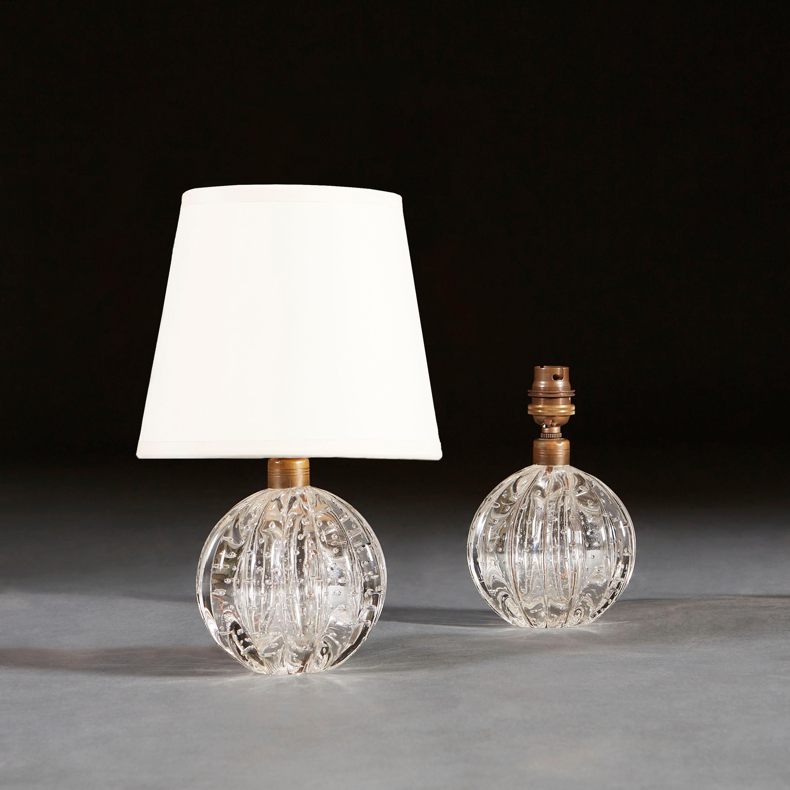 A pair of mid twentieth century bullicante Murano glass ball lamps, with gadrooning throughout Bullicante is a technique used in Murano glass to create controlled bubbles throughout a piece.

Currently wired for the UK.

Please note: lampshades