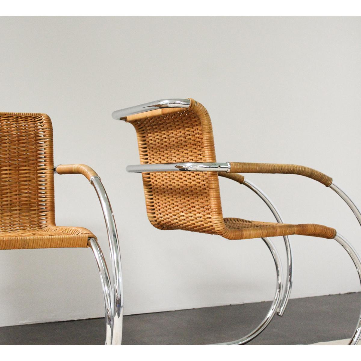 A pair of vintage 'MR20' cantilevered cane armchairs by Mies van der Rohe for Knoll International. This chair is a version of the chair Mies presented in 1927 at the Stuttgart Weissenhof Estate — a seminal Werkbund exhibition in Germany. The MR20