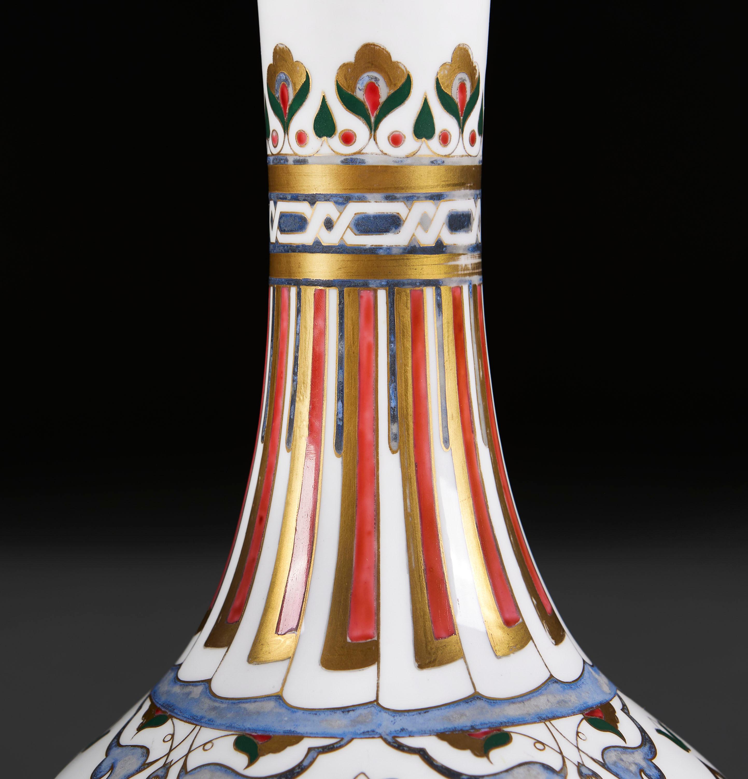 England, circa 1880

A pair of mid nineteenth century Minton pottery vases, in Turkish Iznik style, designed by Christopher Dresser, the white ground overlaid with gilt red and blue decoration, with floral designs to the body and fan motif to the