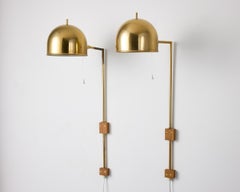 A pair of model V-75 wall lamps by Eje Ahlgren with Polished Brass Domes