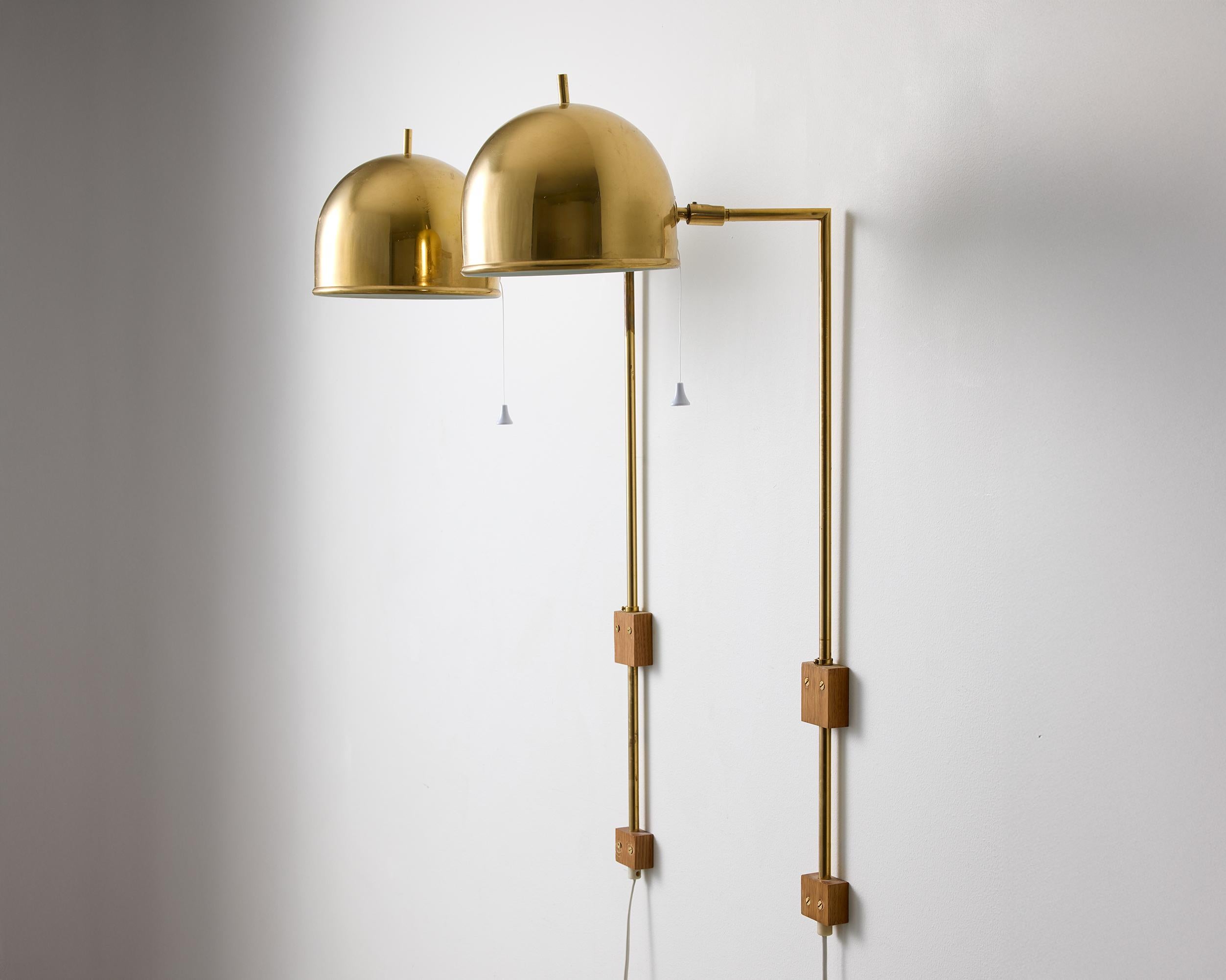 A pair of model V-75 wall lamps by Eje Ahlgren with Polished Brass Domes For Sale 1