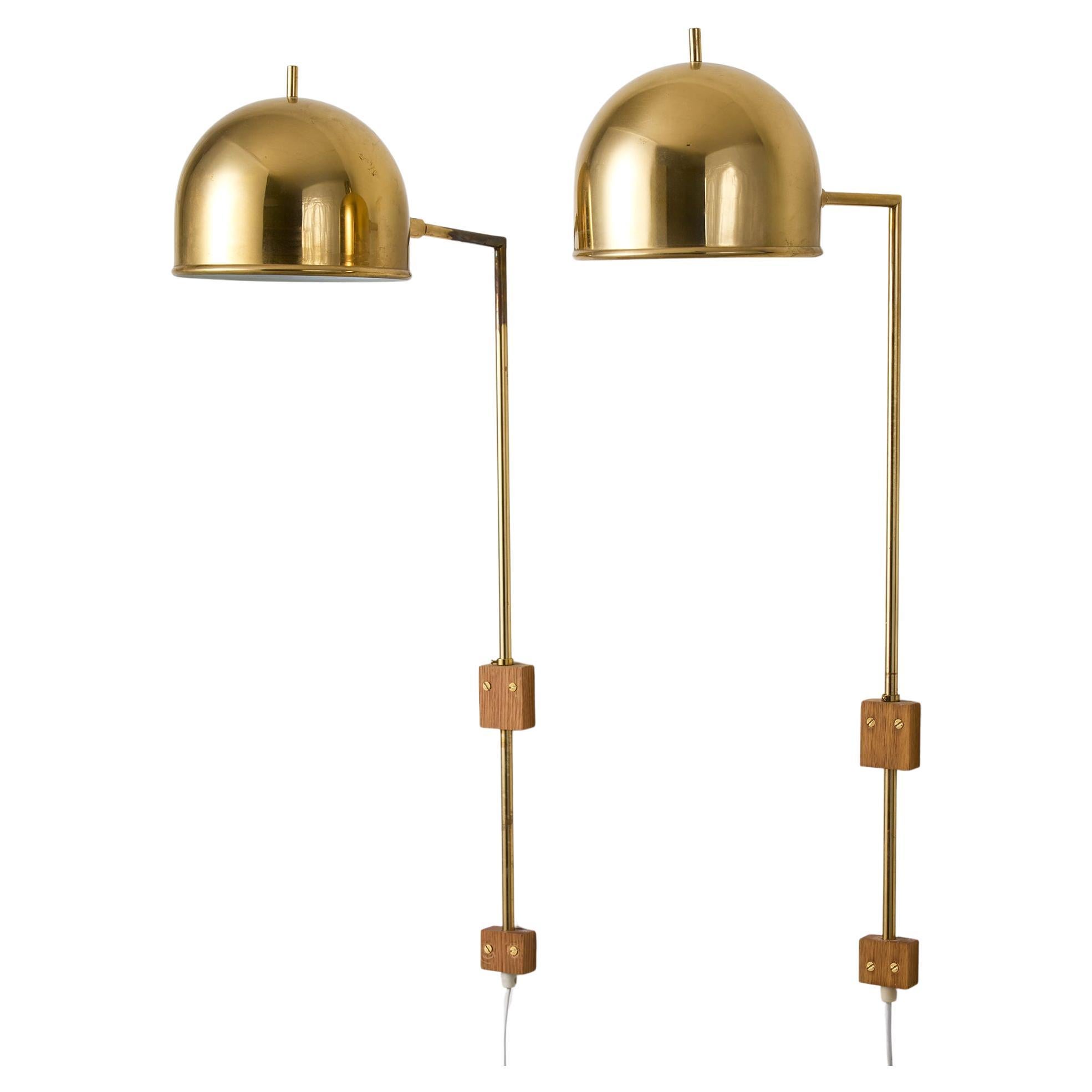 A pair of model V-75 wall lamps by Eje Ahlgren with Polished Brass Domes For Sale