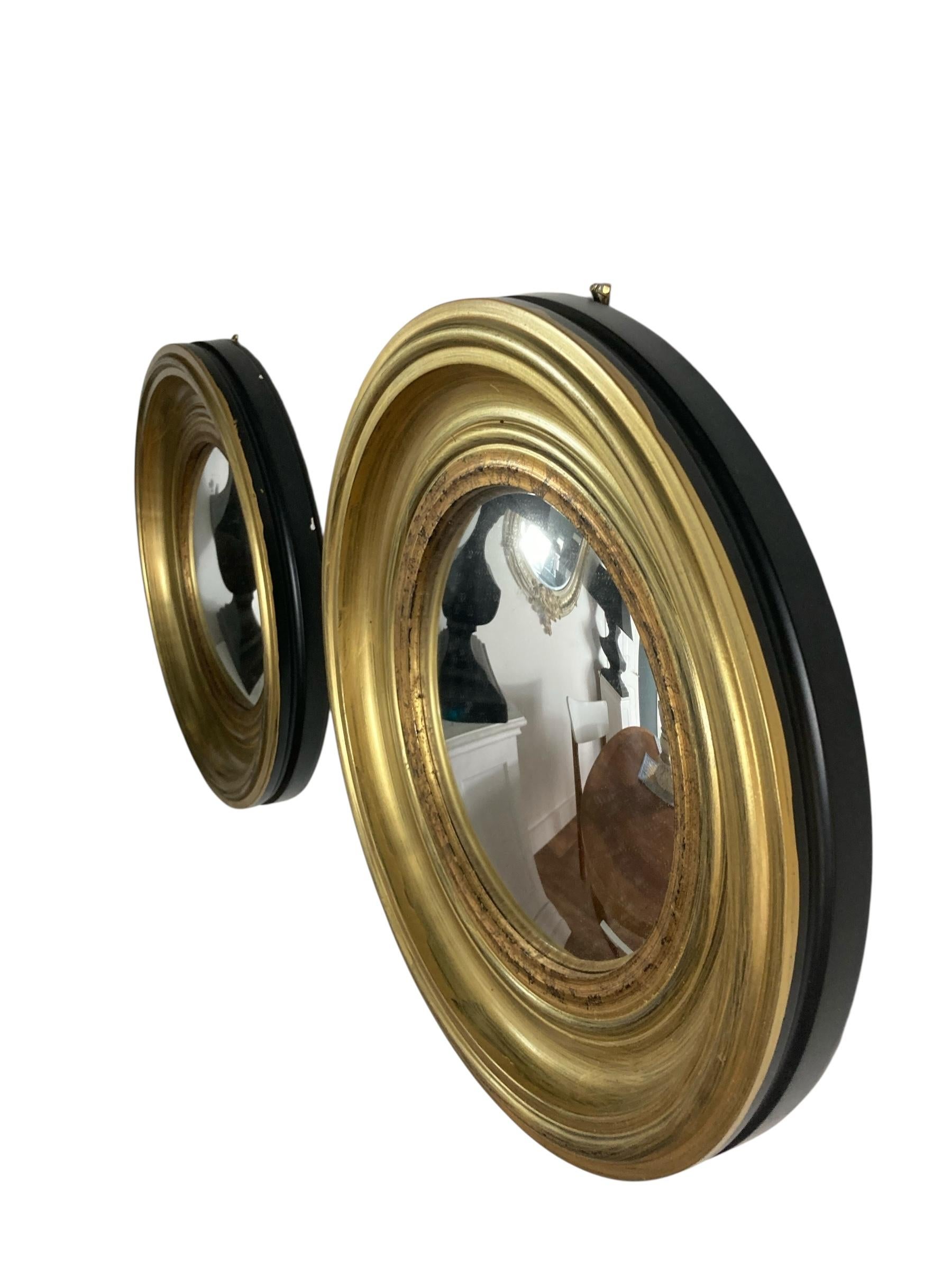 A Pair of Modern Regency Style Gold Circular Convex Mirrors with ebonsied Rim In Good Condition For Sale In Bishop's Stortford, GB