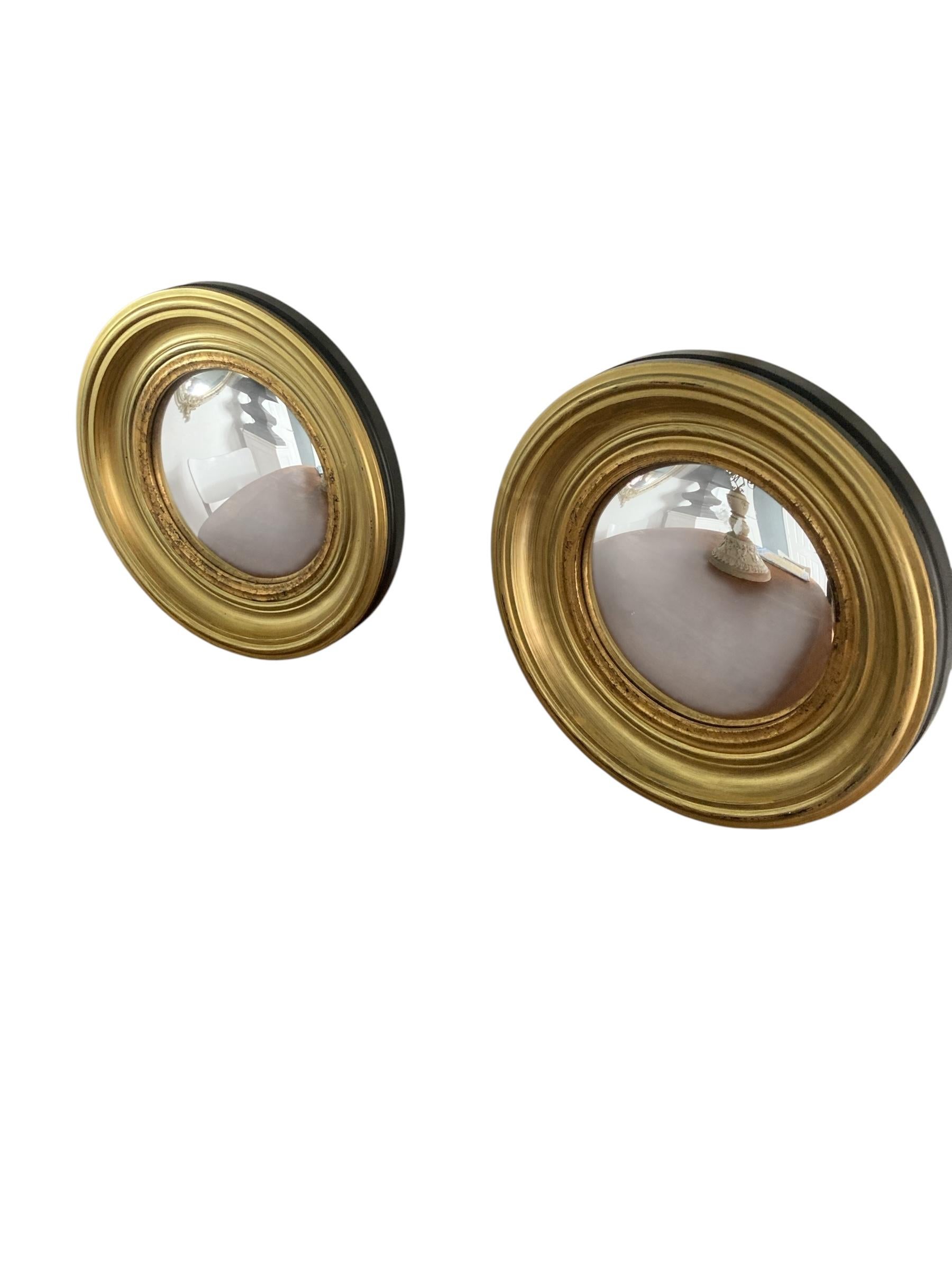 Late 20th Century A Pair of Modern Regency Style Gold Circular Convex Mirrors with ebonsied Rim For Sale