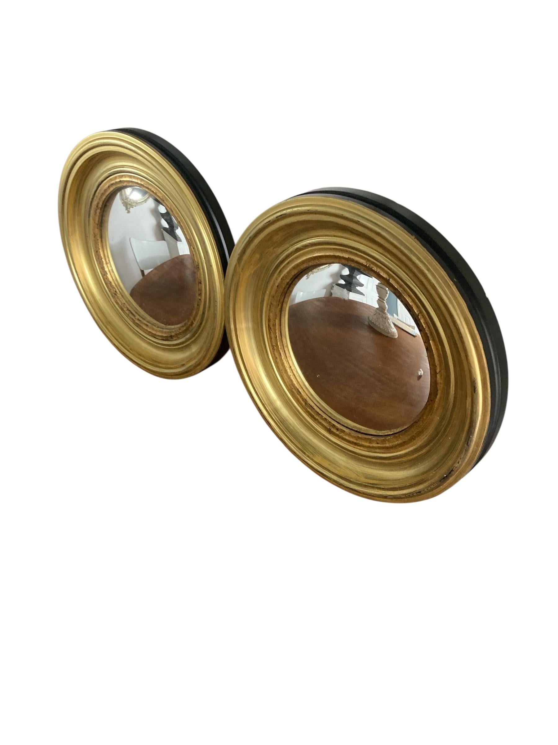 A Pair of Modern Regency Style Gold Circular Convex Mirrors with ebonsied Rim For Sale 1