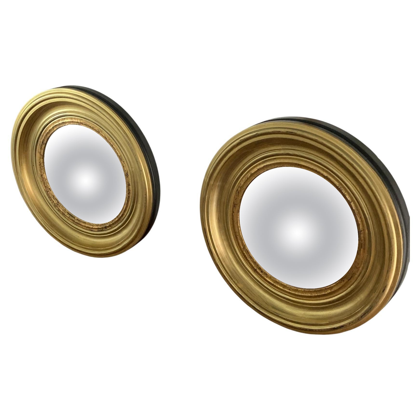 A Pair of Modern Regency Style Gold Circular Convex Mirrors with ebonsied Rim For Sale