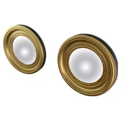 A Pair of Modern Regency Style Gold Circular Convex Mirrors with ebonsied Rim