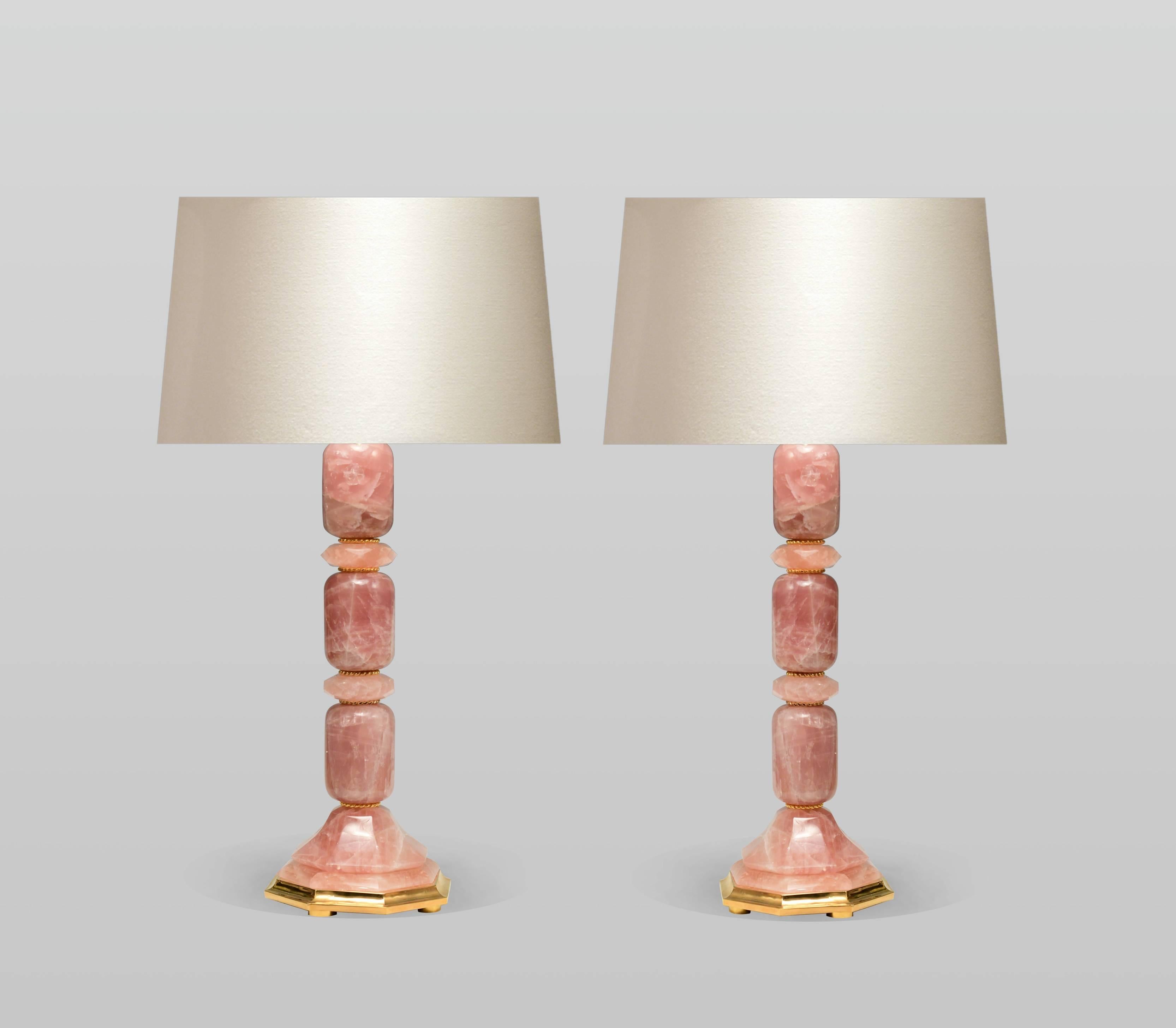A pair of modern rose rock crystal table lamps with polish brass bases.
Measures: 8