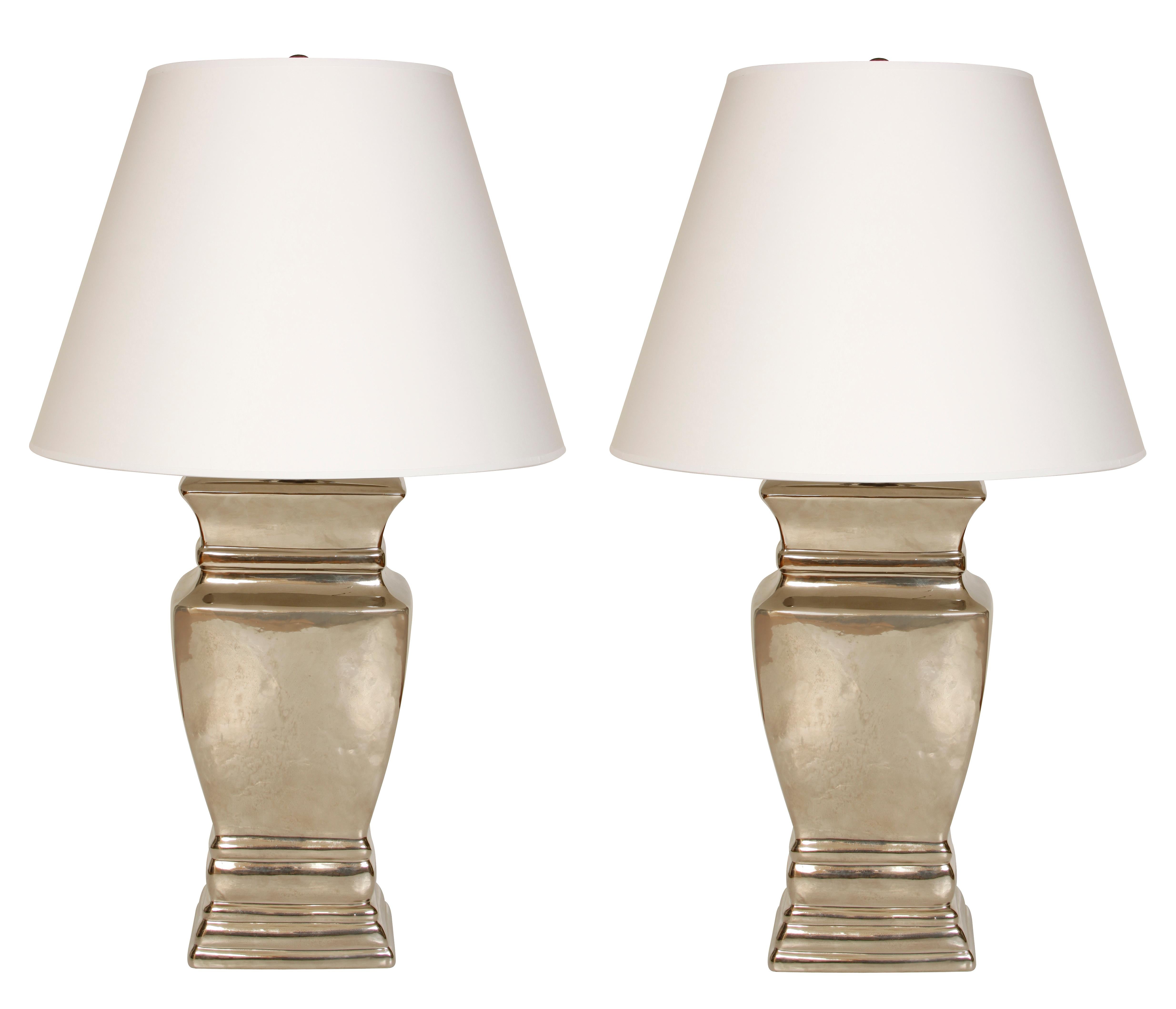 A pair of modern silvered ceramic lamps.