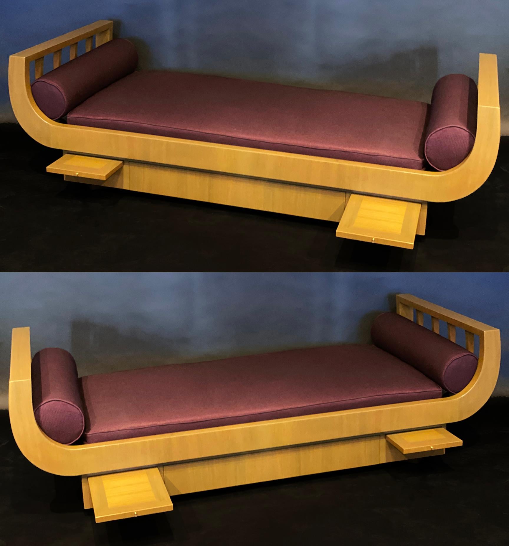 A fine pair of American modern daybeds by James Mont. The matching pair of beds have curved open-armed framework, supporting the bolstered fabric end pillows.
Each of these unusual daybeds feature a pair of slide out functional trays for a