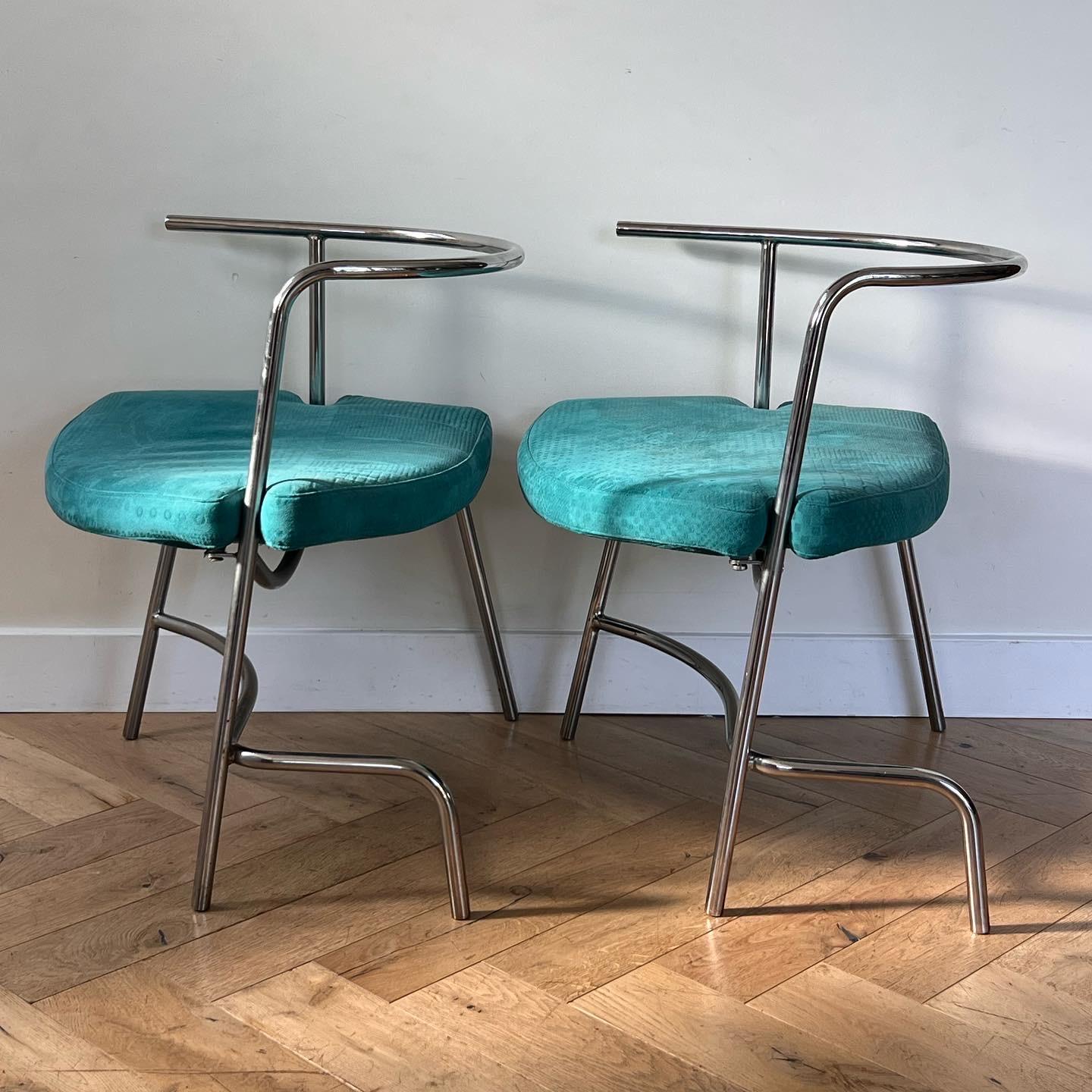A rare pair of modernist Bauhaus Italian armchairs after Giotto Stoppino and Guido Faleschini, circa 1970. Featuring geometrically unique - and asymmetrical - chrome frames and original turquoise blue upholstery over broad triangular seats. The