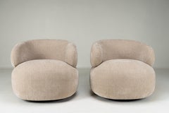 A Pair of Modernist Lounge Chairs on Swivel Bases
