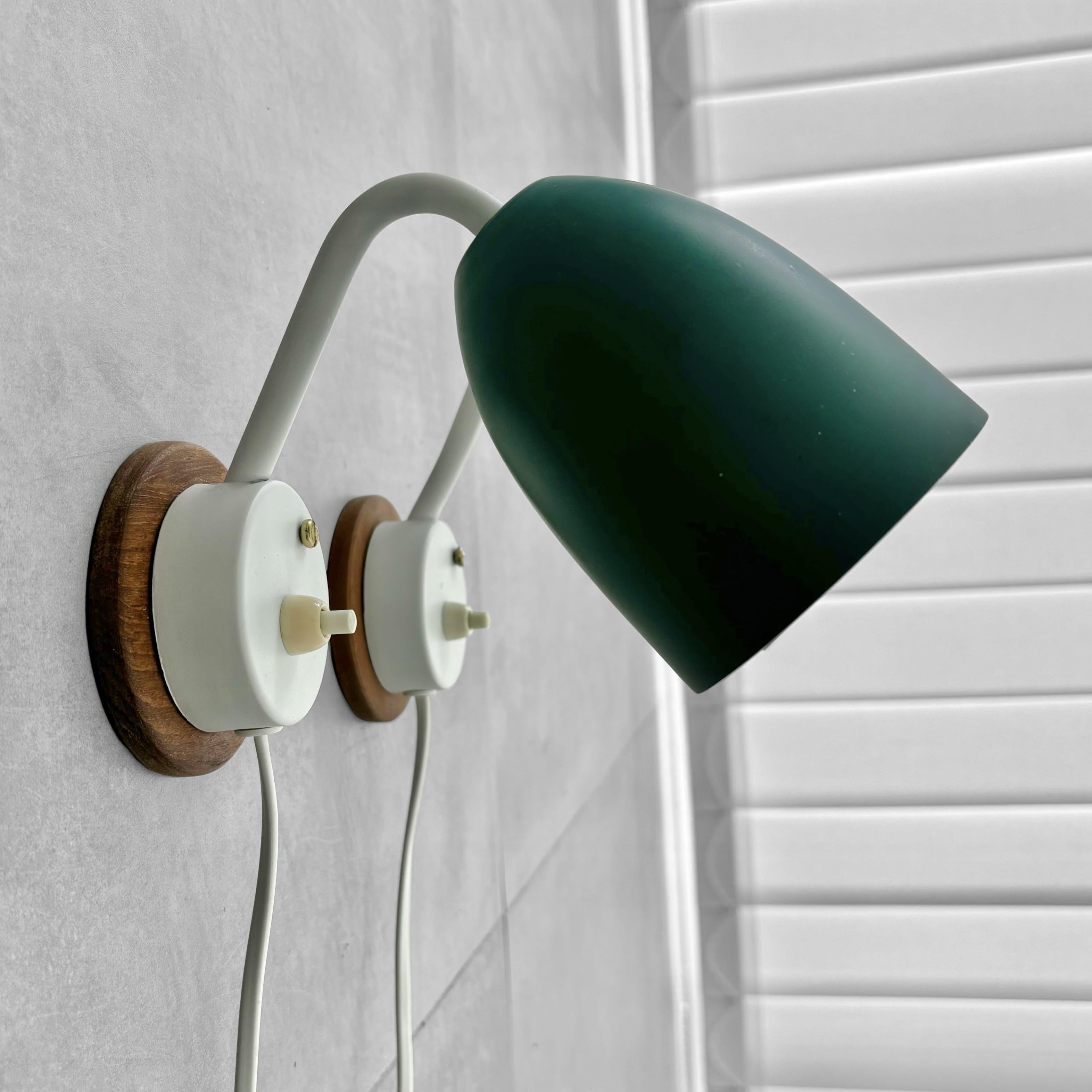 Aluminum A pair of modernist Scandinavian wall lamps, steel and oak, Sweden, 1950s For Sale