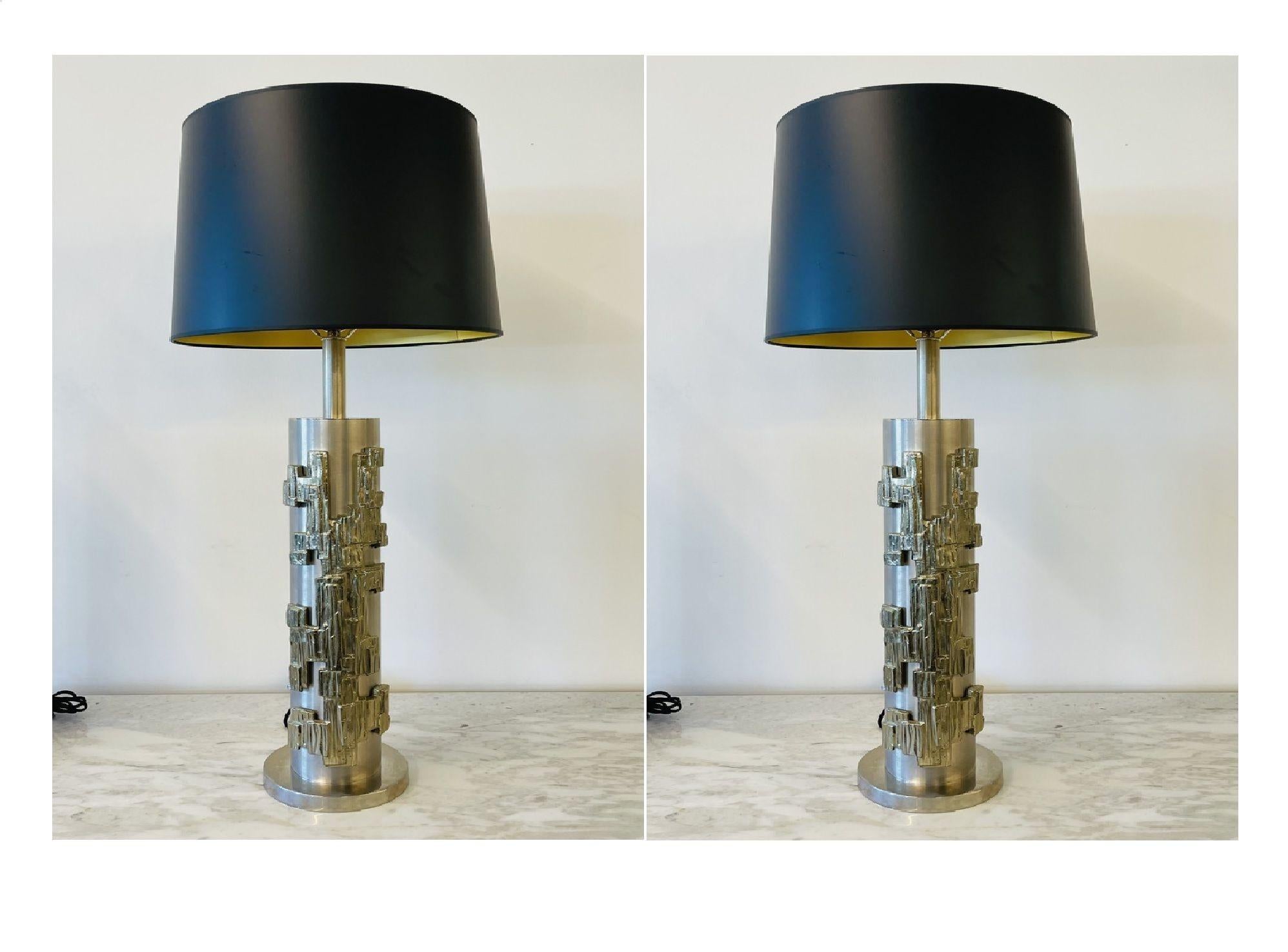 A pair of modernist table lamps, Brushed Nickel and Sculptural Metal, circa 1970s.
 
Brushed Nickel and Gilt Metal Brutalist, Geometrically Inspired Lamps, recently re-wired; shades not included. 
 
36 H x 6 diameter.
 
1 x e26 standard socket
