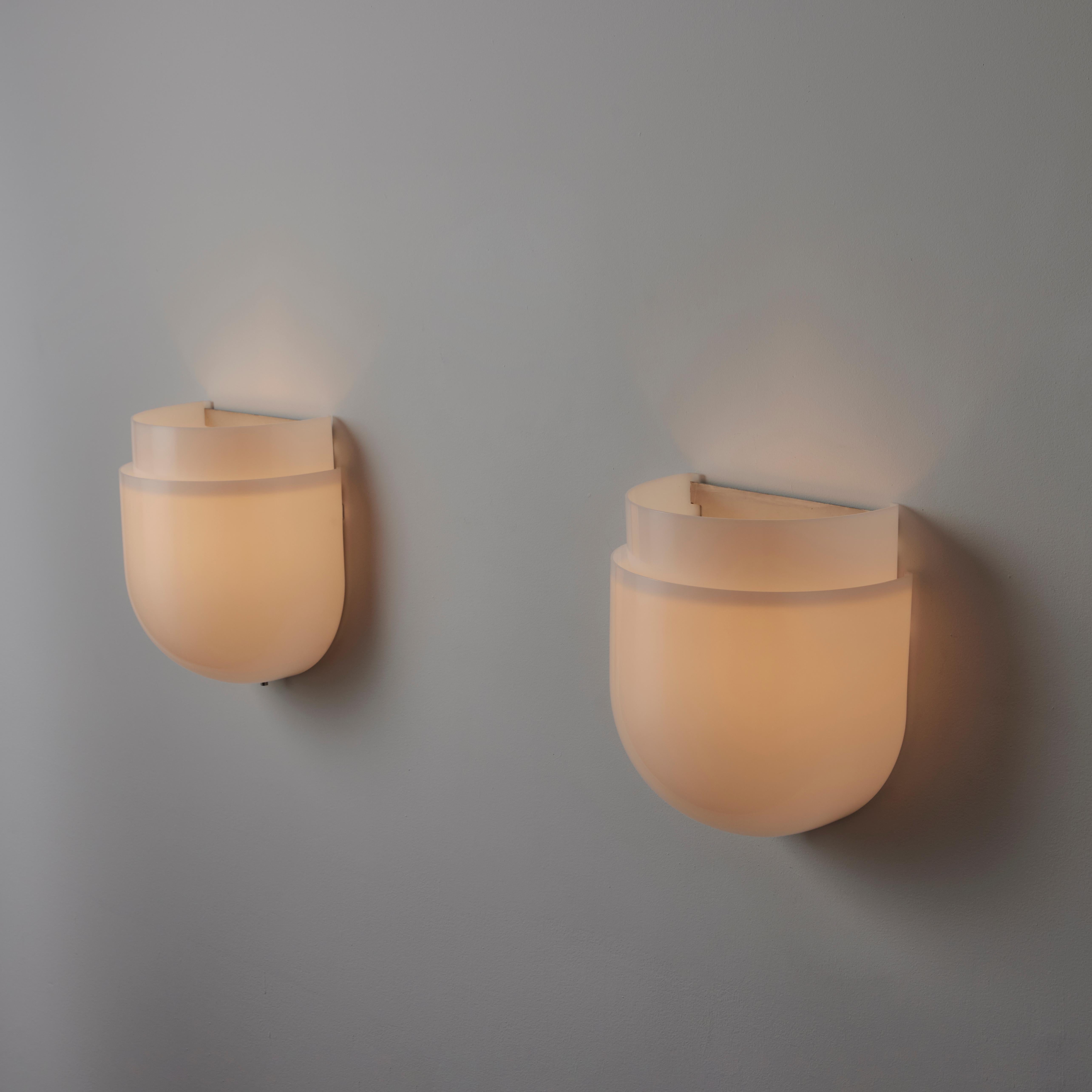 'Montparnasse' Sconces by Sergio Asti for Candle. Designed and manufactured in Italy, circa the 1970s. Double-breasted white acrylic shields form these minimal sconces. Each sconce holds an E27 socket type, adapted for the US. We recommend a 25 to