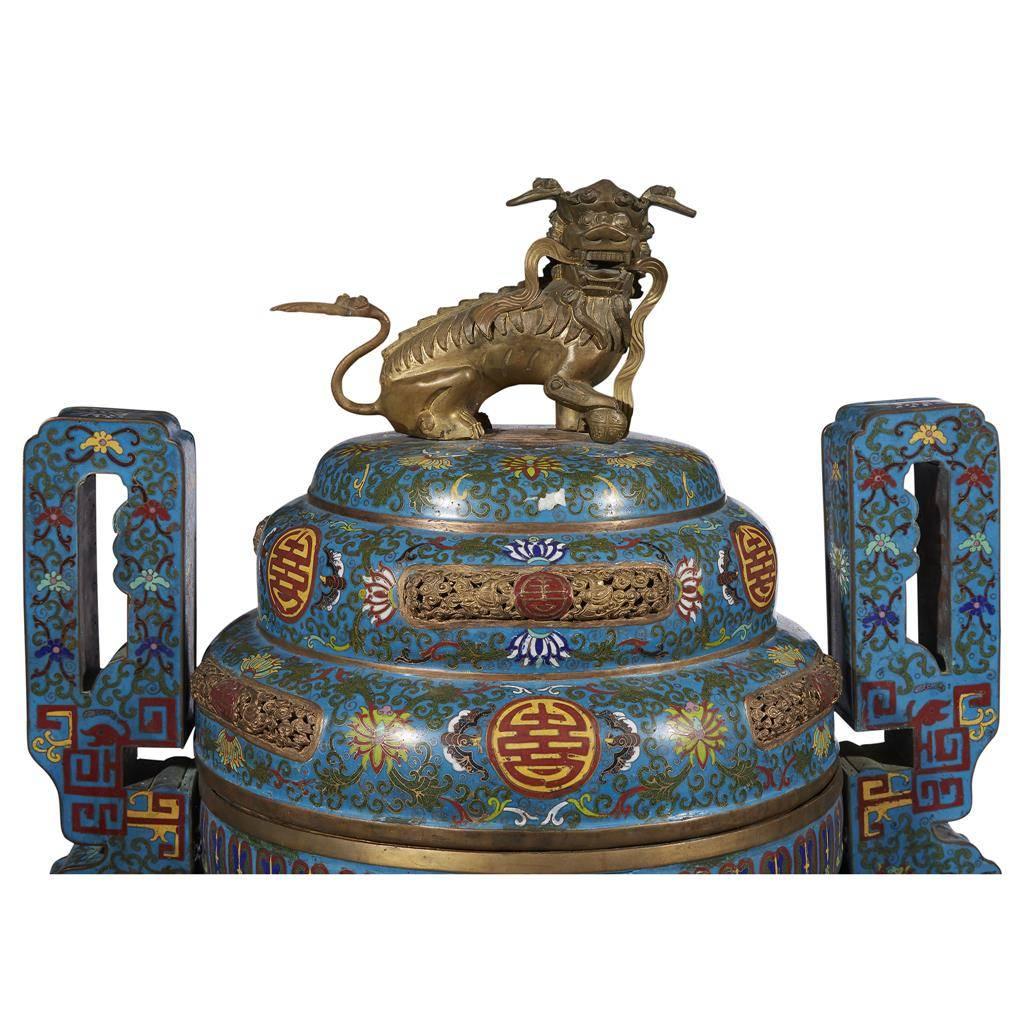 A pair of massive / monumental Chinese blue cloisonné enamel censers,
early 20th century

Each with two-handled cylindrical bodies raised on three legs, with domed covers and lion finials, sitting on a pair of carved wood stands.

The cloisonné