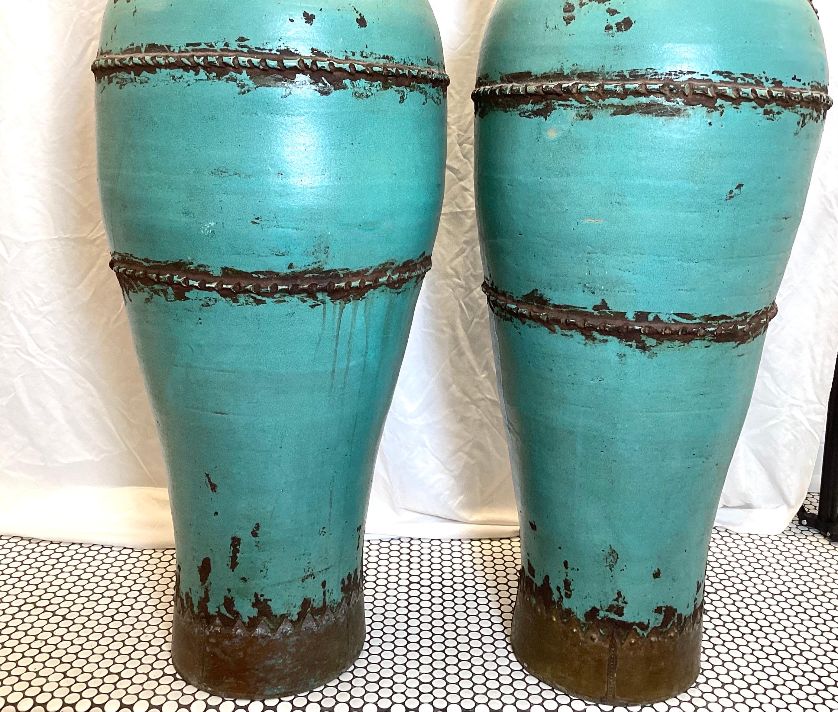 A Pair of Monumental Four Handled Tall Pottery Urns In Good Condition For Sale In Lambertville, NJ