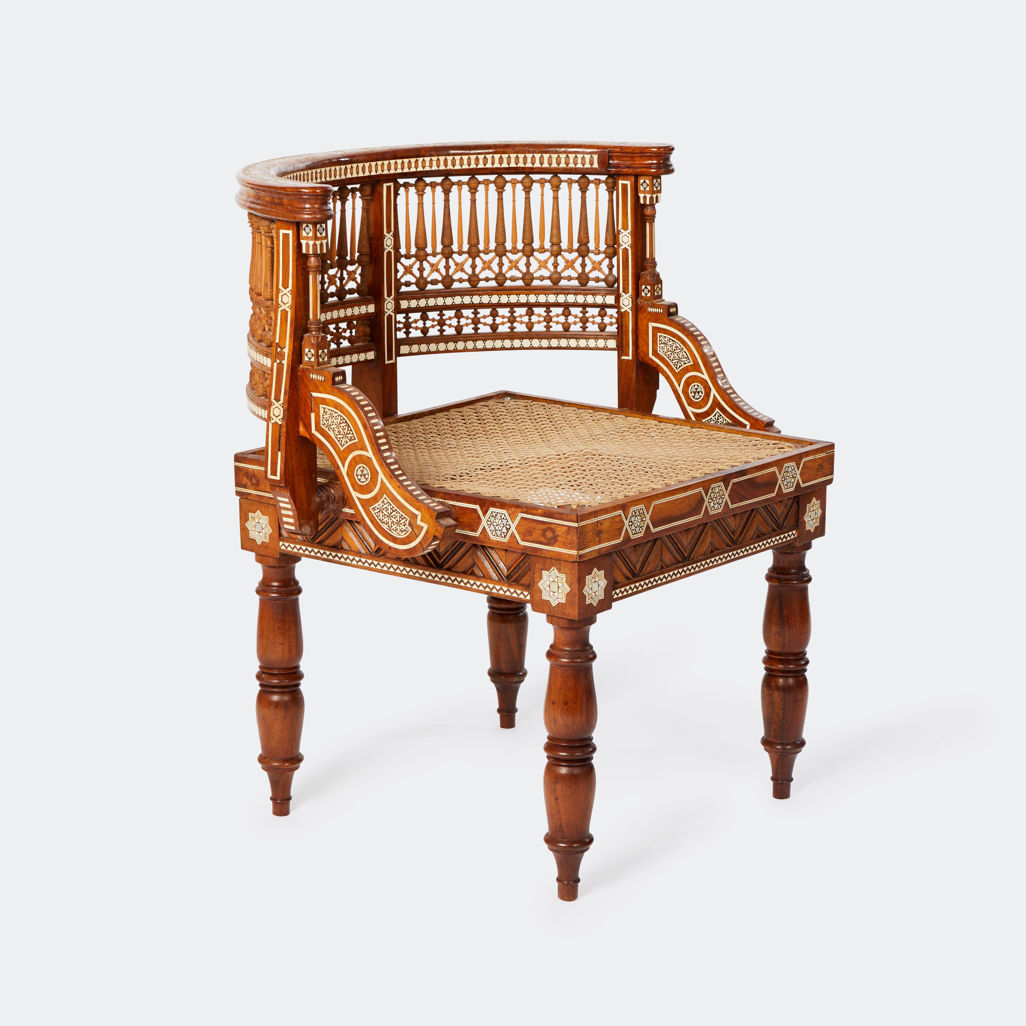 A pair of Moroccan inlaid chairs with turned legs and carved open work Mashrabiya backs. Rosewood with faux ivory inlay. Circa 1900. 