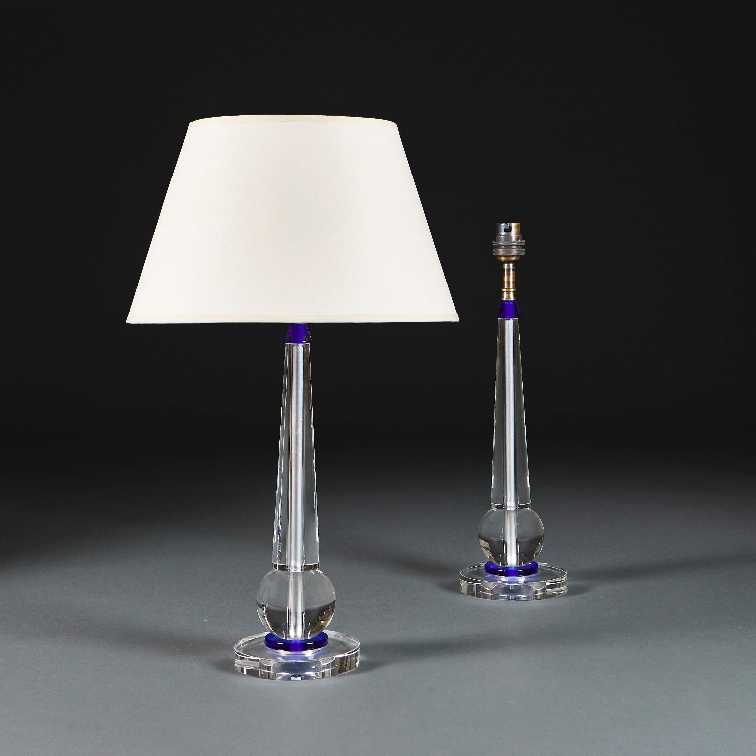 Italy, Murano, circa 1940

A pair of twentieth century large clear and blue Murano glass baluster lamps supported on a circular base.

Height 43.00cm
Height with shade 68.00cm
Diameter of base 15.50cm.

Please note: This is currently wired for the