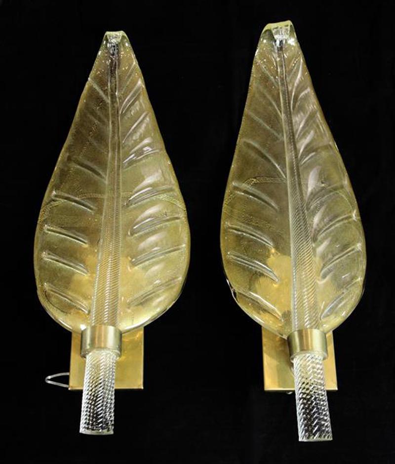 A pair of Murano glass leaf-form wall lights by Barovier & Toso.

Italian, circa 1960. 

Each light is in the form of a leaf with a spiral twisted stem and set on gilt backplates. The reverse of the glass is made with a 'Rugiadoso' technique,