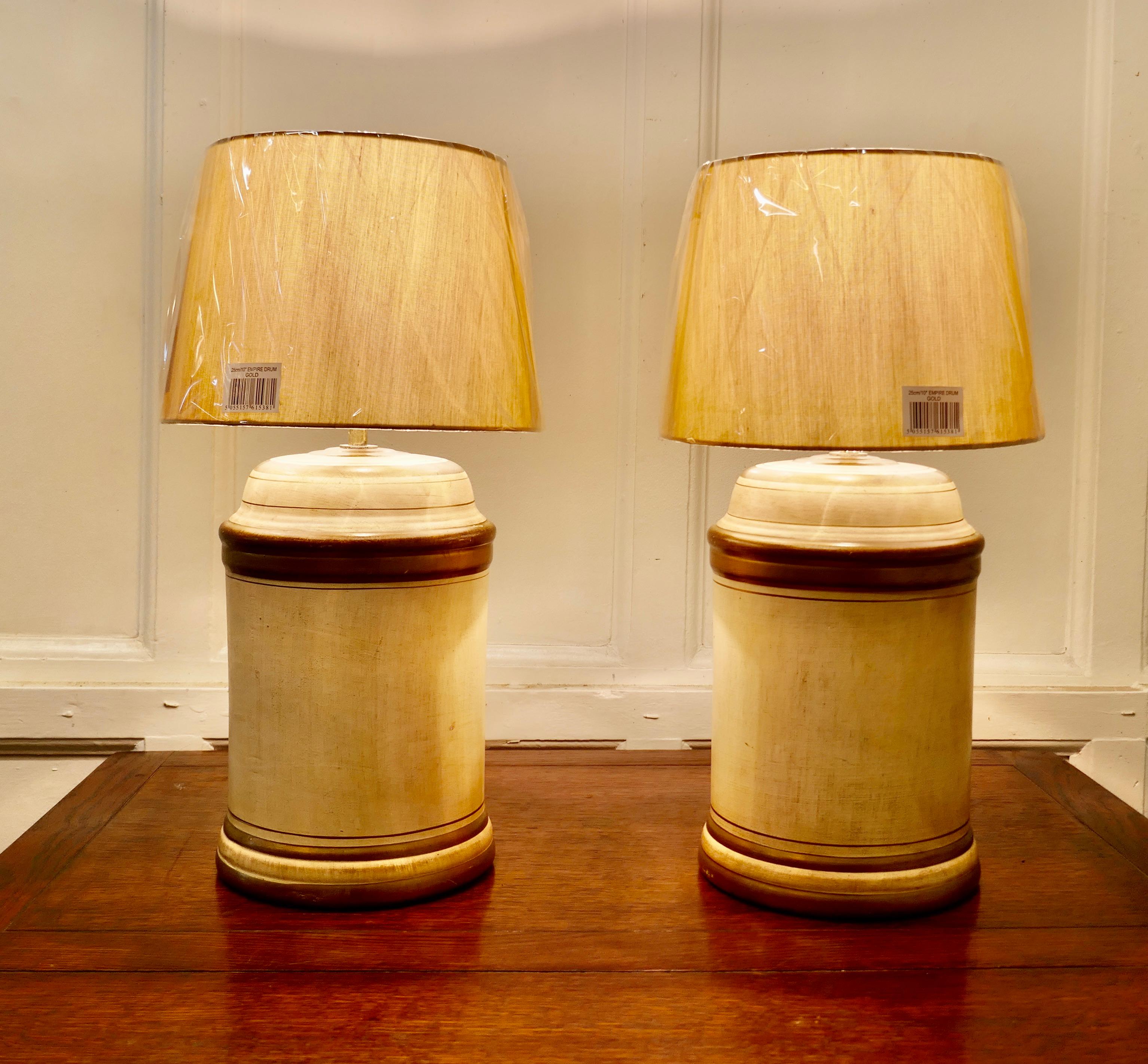 A pair of mustard yellow table lamps

A great pair of lamps with new matching shades, both lamps have age mellowed slightly distressed finish with dark gold detail
The lamps are fully wired and in good condition, a statement piece in any