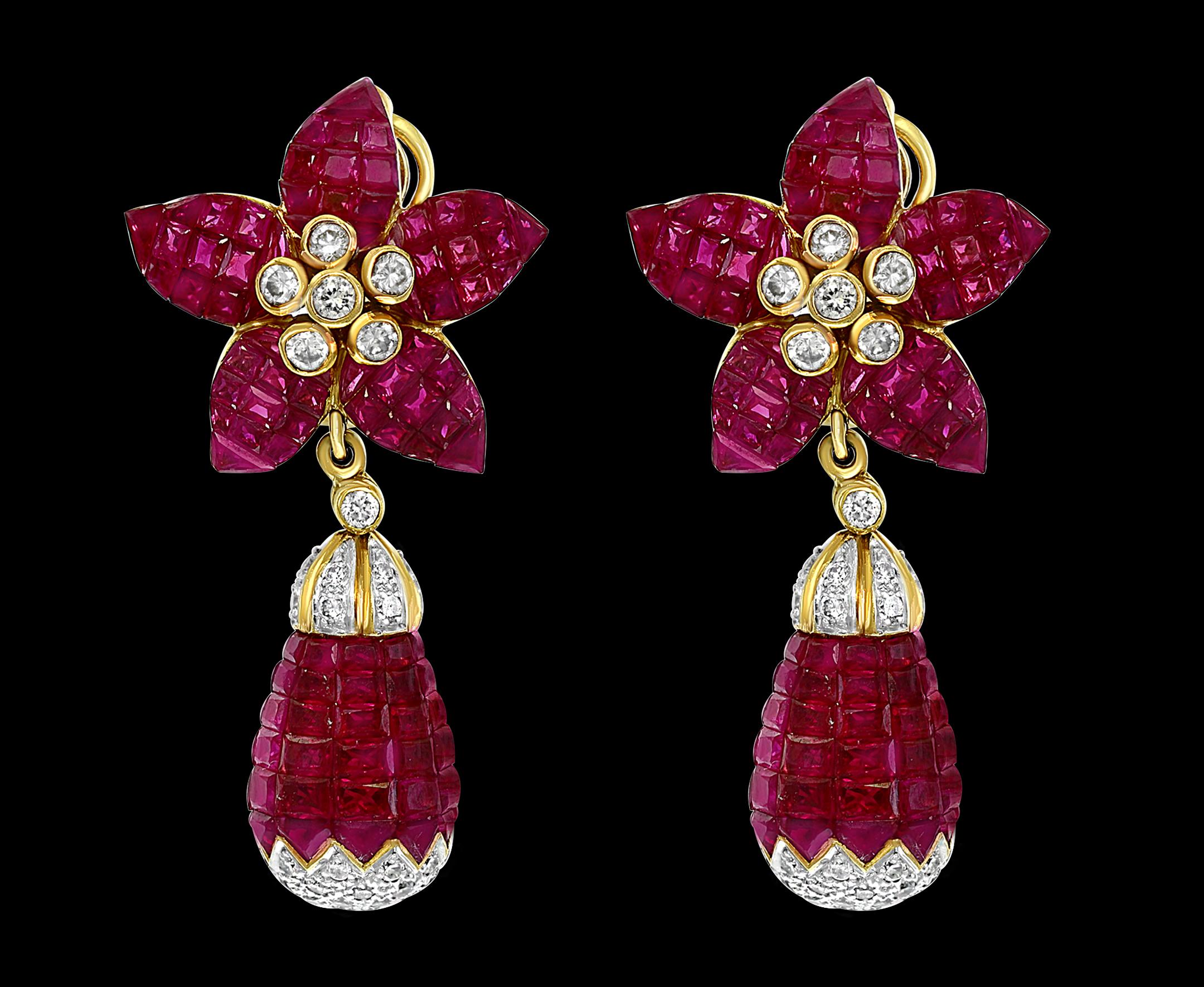 Invisible or Mystery set  Princess cut  Burma Ruby  And  Diamond  Cocktail   Earring in 18 K  Yellow Gold  . 
Another triumph of invisible setting. In these dangle earrings.
Princess-cut rubies are invisibly set in the drop which fall from a