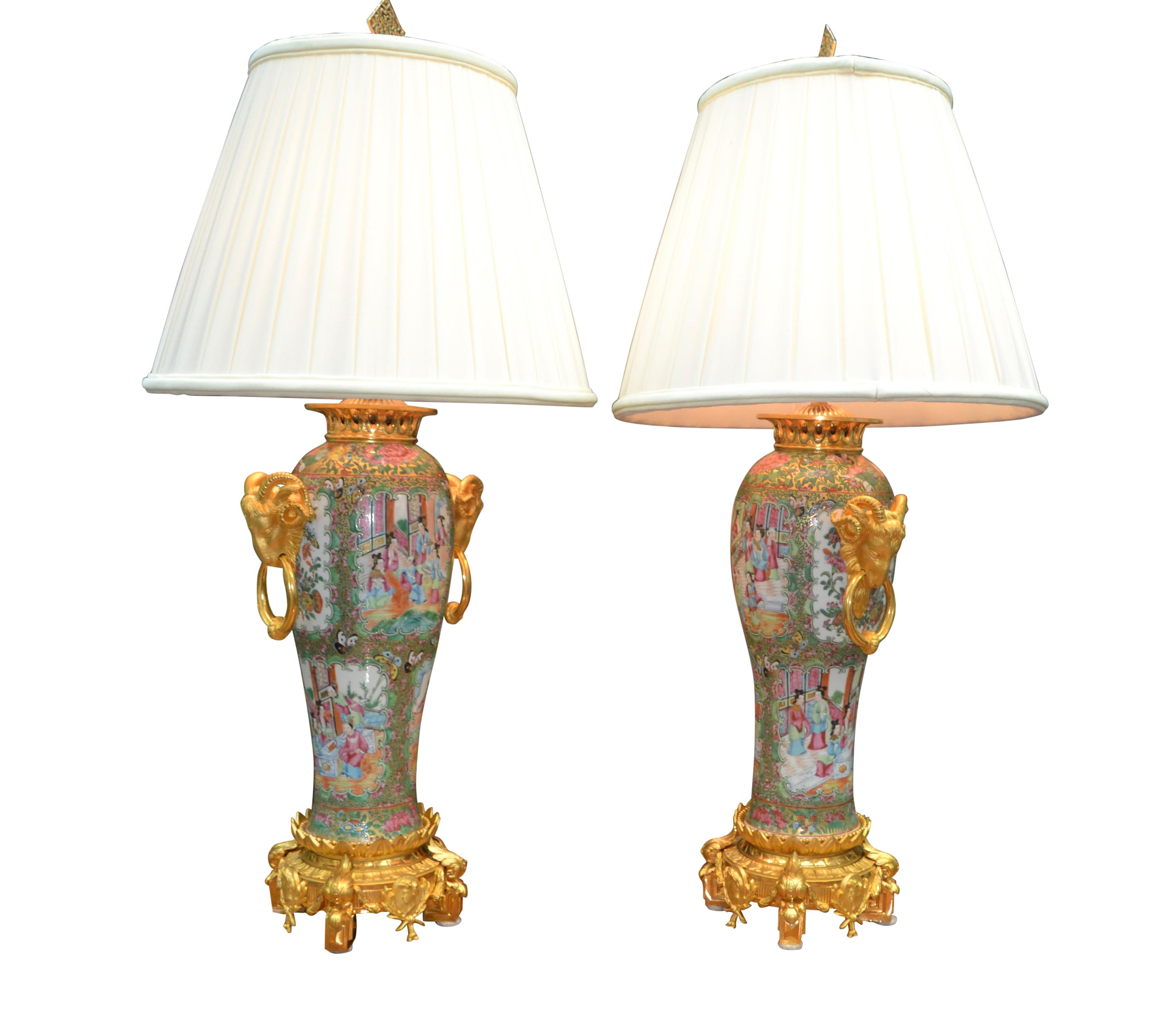 A fine and rare large scale Chinese porcelain and gilt bronze mounted vases converted into lamps. The vases are characterized by hand painted Famille Rose medallion design and richly embellished with finely chased and gilded bronze mounts including