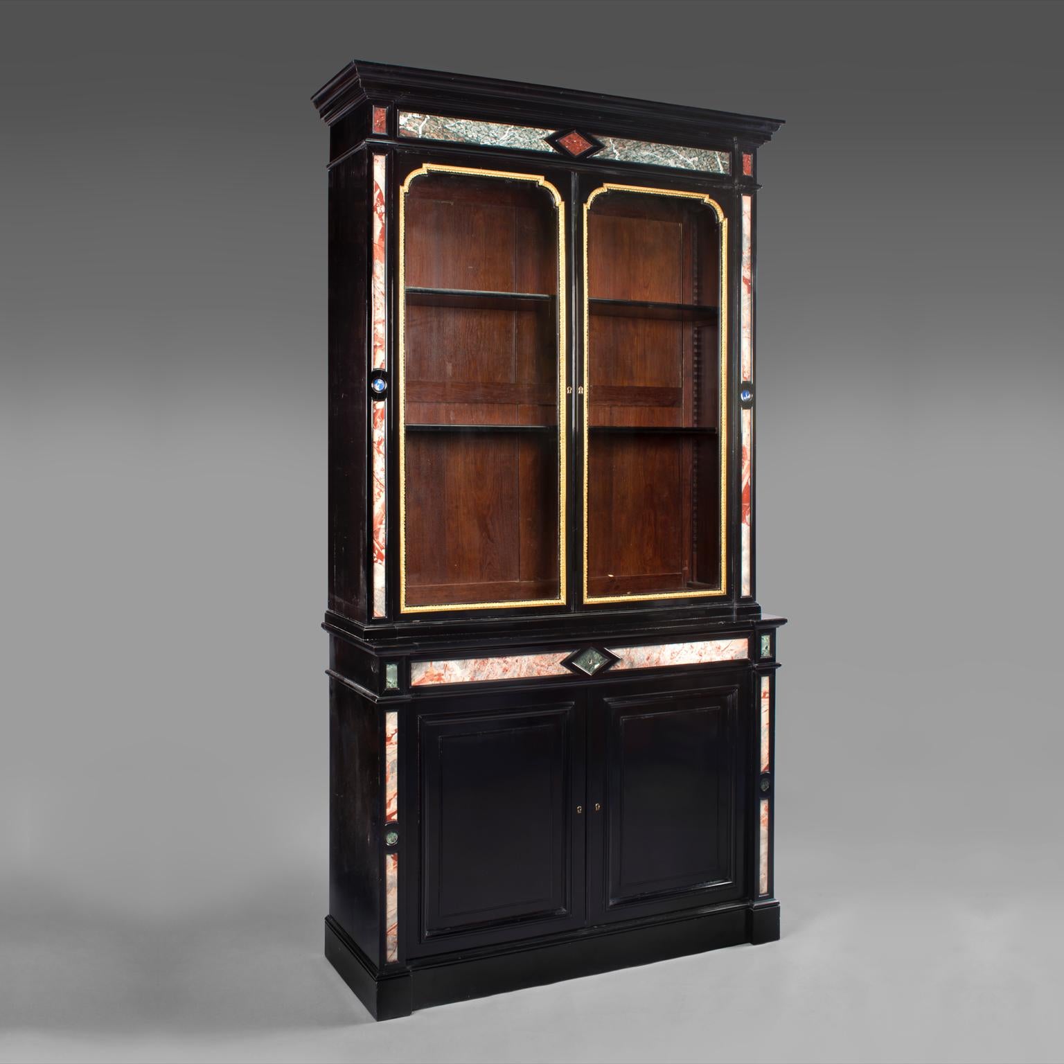 A Very Fine Pair of Napoleon III Style Pietre Dure Bookcases Attributed to Auguste-Hippolyte Sauvrezy (1815-1854).

This exceptional pair of ebonised bookcases each have a moulded cornice above a pair of glazed doors set within finely cast