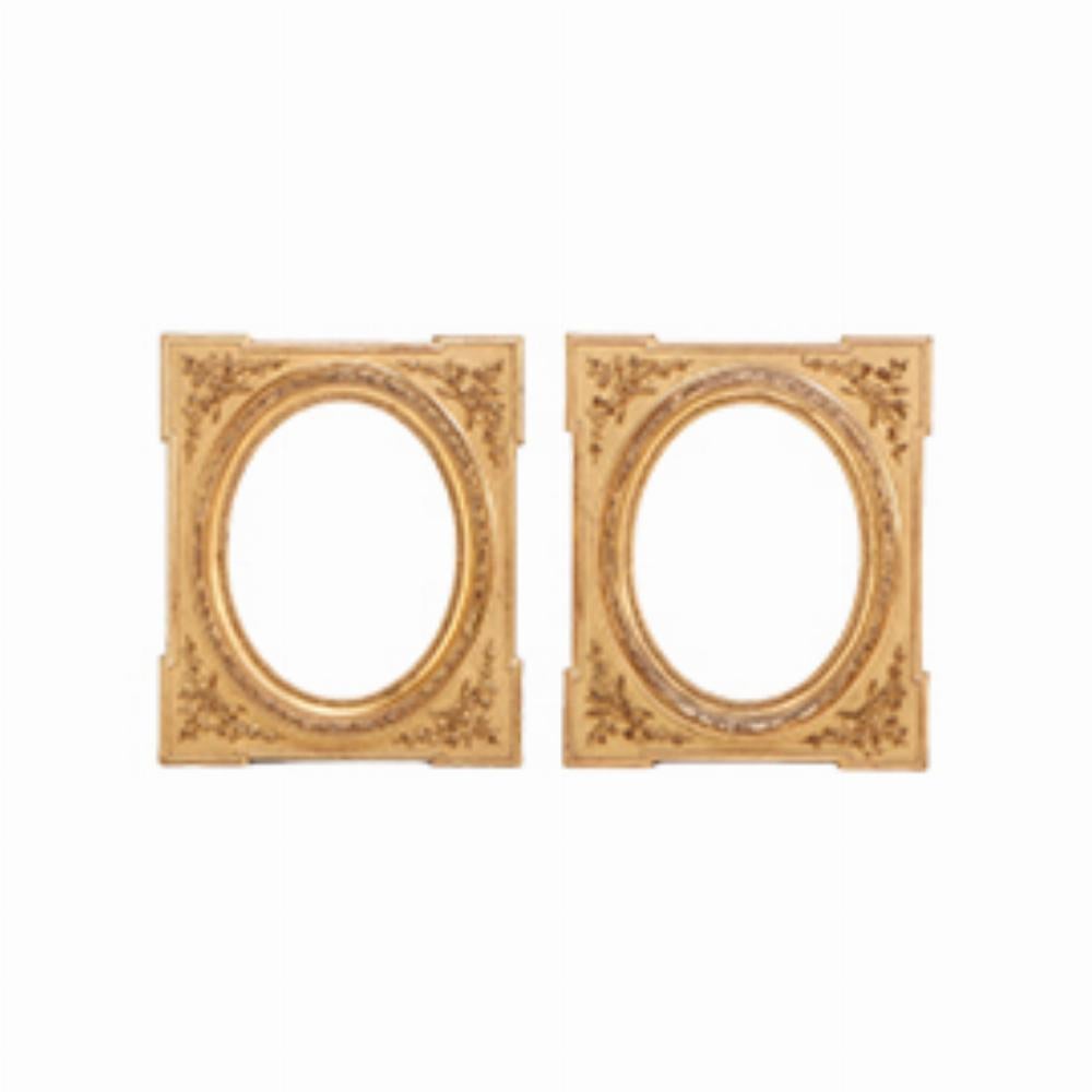 A Pair of Napoleon III style giltwood and gesso picture frames, 19th C. having oval openings and relief branch and leaf embellishments on frames.