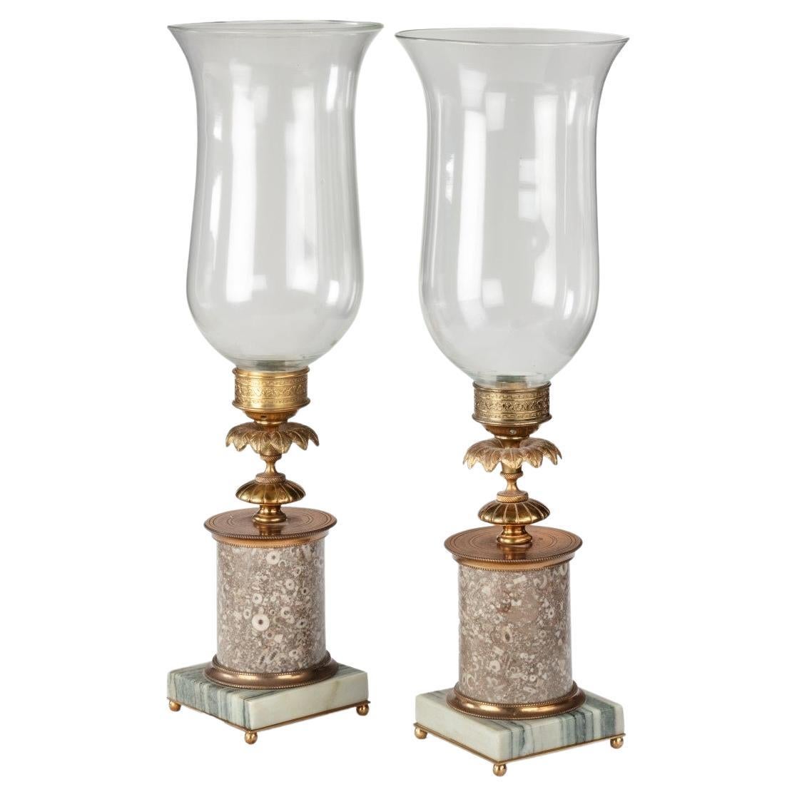 A pair of decorative storm lamps